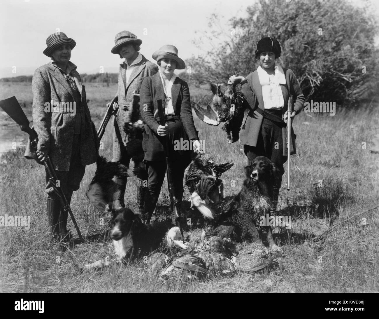 Five women hunters posed with their guns, dogs, and dead birds, ca. 1920. (BSLOC 2015 17 167) Stock Photo