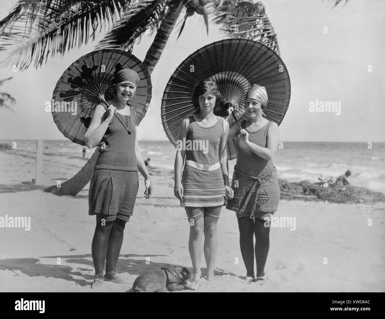 Women pose in bathing suits at an American east coast beach between 1910-1920. The younger woman in the center has bare legs, but the others wear stockings. (BSLOC 2015 17 201) Stock Photo