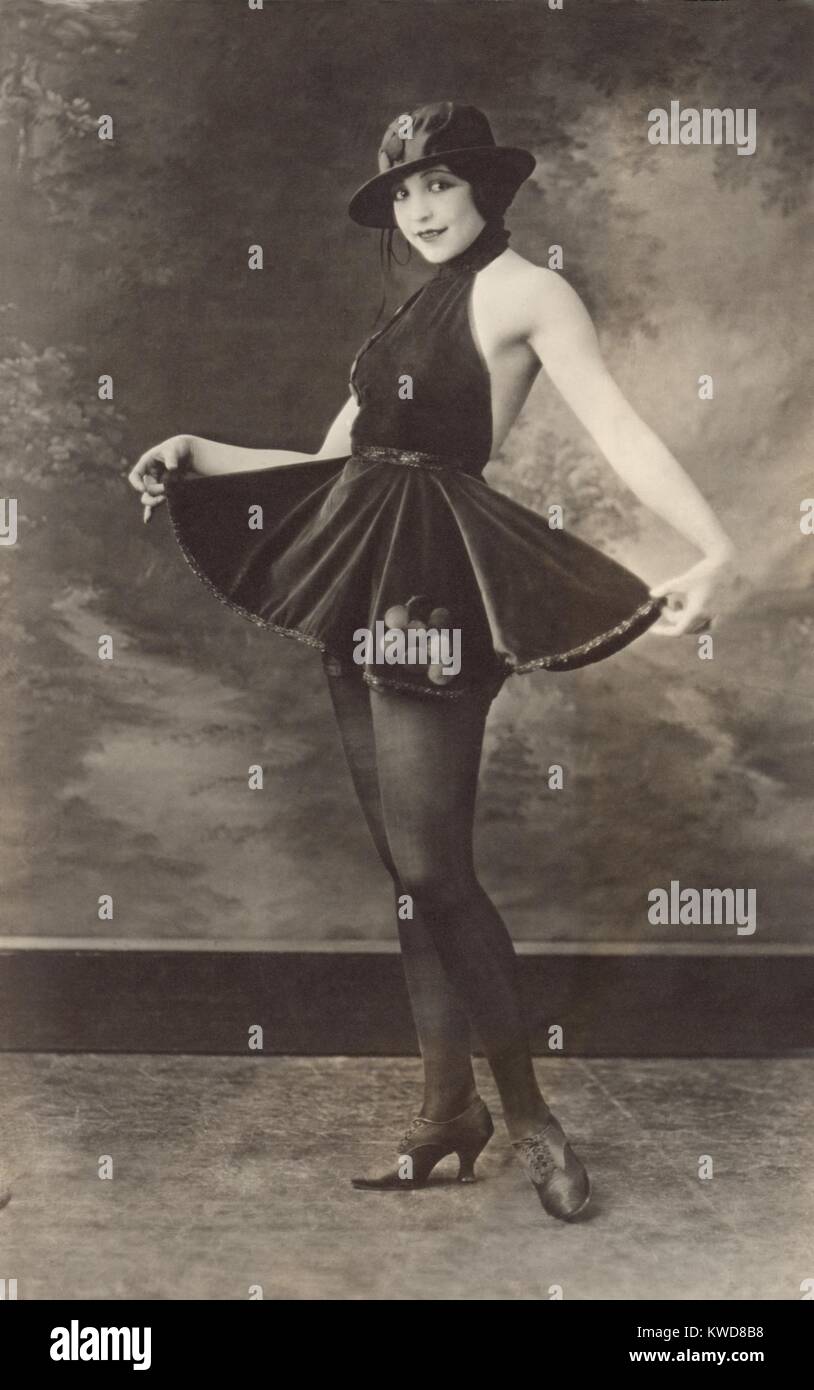 'The Entertainer,' a photo-postcard, of a full-length portrait of a woman wearing hat, short skirt and dark sheer tights. Dec. 14, 1921. (BSLOC 2015 17 218) Stock Photo