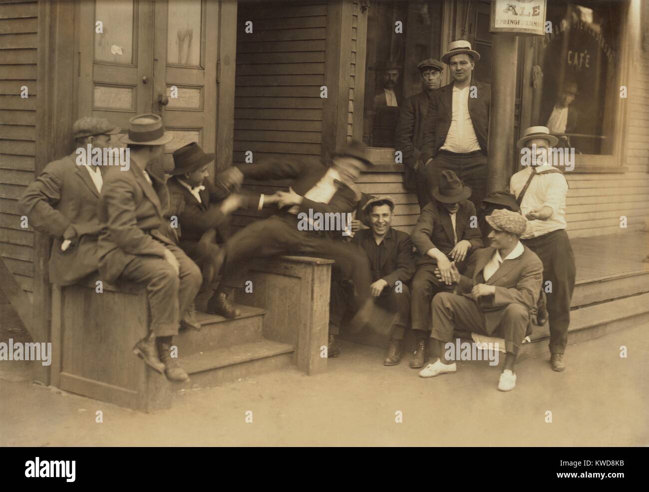 Young men hanging around a saloon in Chicopee Falls, Massachusetts, June 29, 1916. They are in good cheer, including the fellow falling off his seat, Photo by Lewis Hine (BSLOC 2016 7 6) Stock Photo