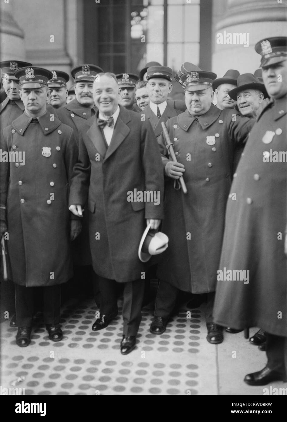 Billy Sunday surrounded by police on his arrival in New York City in 1915. The Evangelist was a national celebrity, attracting huge crowds. His entertaining preaching was athletic. His message was often crude, sexually titillating, and graphic (BSLOC 2016 8 117) Stock Photo