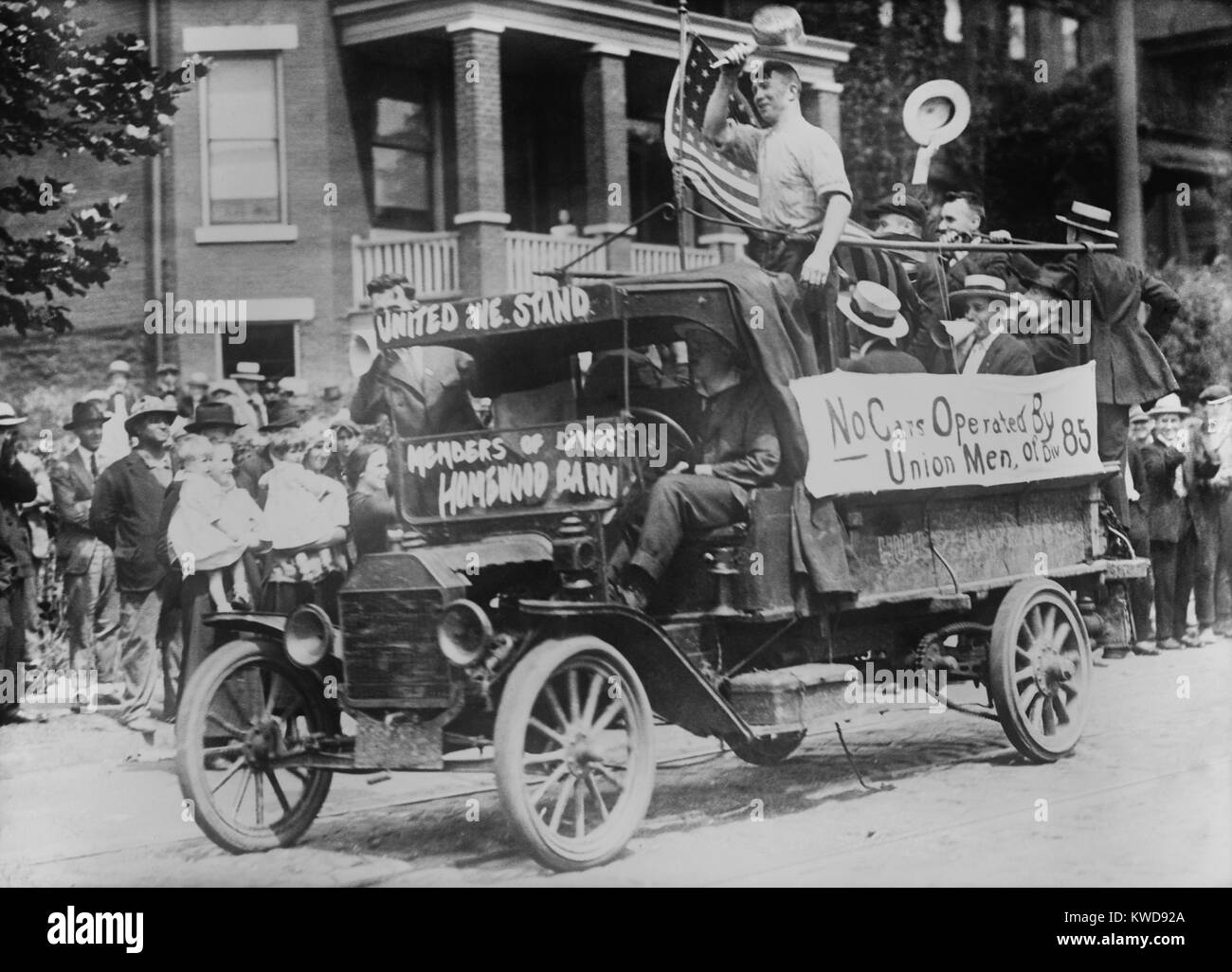 Pittsburgh Streetcar Strike, August 26, 1919. Conductors and motormen from the 'Homewood Barn' parade in trucks with an American flag. Non-lethal violence followed on this day, when the company attempted to run streetcars with strike breakers (BSLOC 2016 8 40) Stock Photo