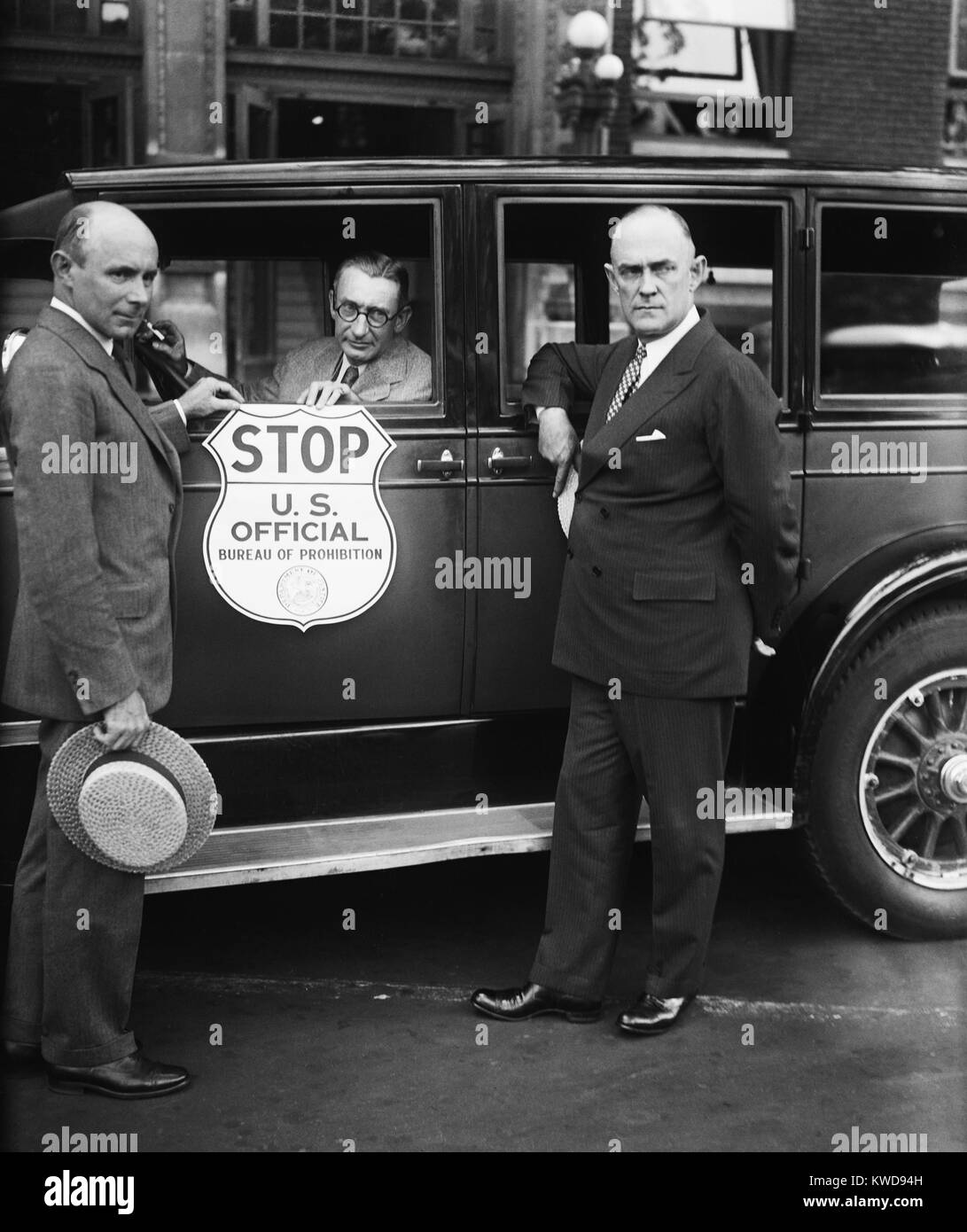 Bureau of Prohibition car used by Treasury agents when stopping suspected vehicles. L-R: Prohibition Administrator Ames Woodcock; H.M. Lucious, Secretary of the Automobile Club of Maryland; and Ernest M. Smith, VP of the American Automobile Association (BSLOC 2016 8 68) Stock Photo