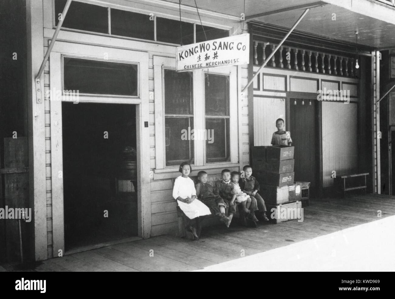 Six Chinese children sit outside the Kong Wo Sang Company in 1926. They are in Newcastle, California, now a small town about 20 miles northwest of Sacramento. It had been a Gold Rush boom town in the 1850s and was on the first line Central Pacific Railroa (BSLOC 2016 8 84) Stock Photo
