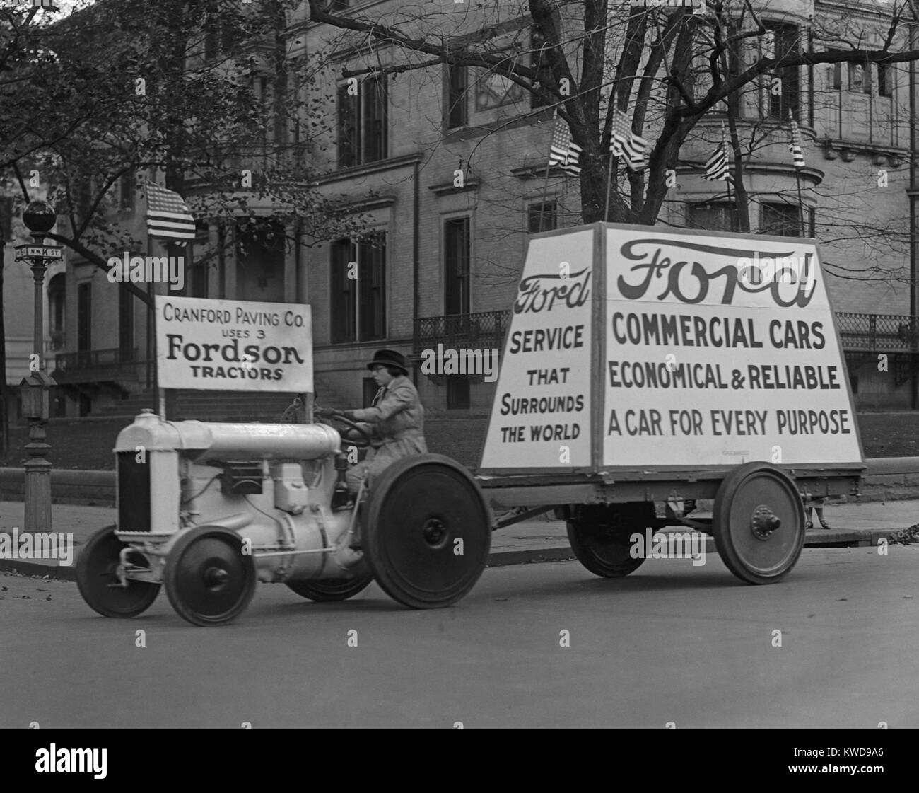 Fordson tractor pulls mobile Ford advertising in Washington, D.C. in 1922. Fordson tractors were reliable, low priced, and affordable for farmers (BSLOC 2016 10 112) Stock Photo