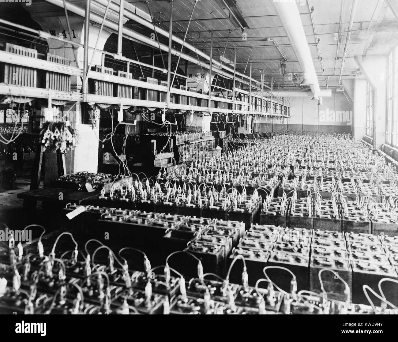 An assembly of 3500 lead-acid batteries at the Ford Motor Company in 1924. With the introduction of electric battery powered starters, drivers no longer had to 'crank' start their car engines (BSLOC 2016 10 43) Stock Photo