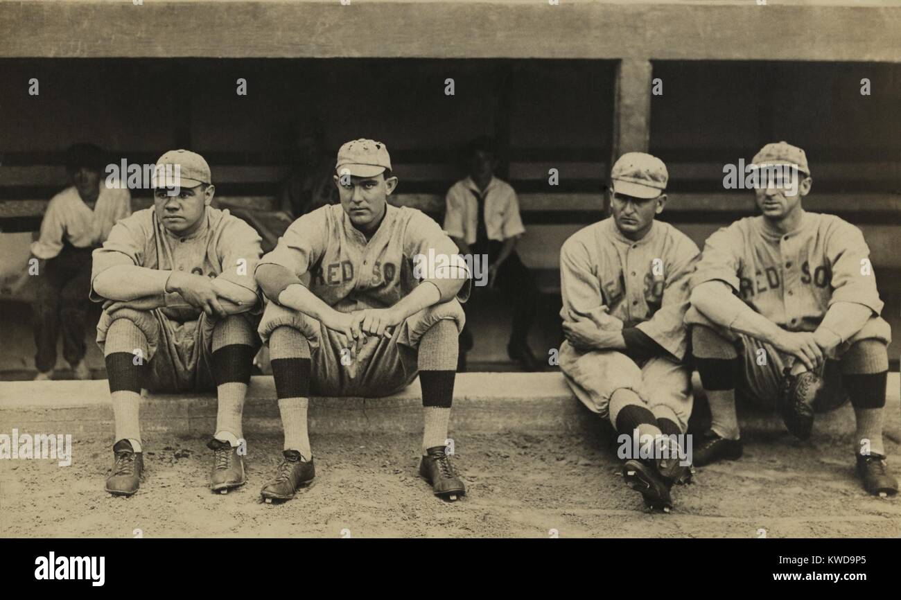 Boston Red Sox players sitting in front of their dugout. L-R: George Herman 'Babe' Ruth; Ernest 'Ernie' Shore; George 'Rube' Foster, and Dellos 'Del' Gainer. Ca. 1917-19. (BSLOC 2015 17 19) Stock Photo