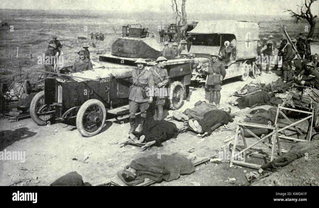 World War 1. Somme Offensive. British soldiers wounded in the Battle of the Somme await evacuation beside an armored car and ambulance at a medical station near Guillemont, France. (BSLOC 2013 1 126) Stock Photo