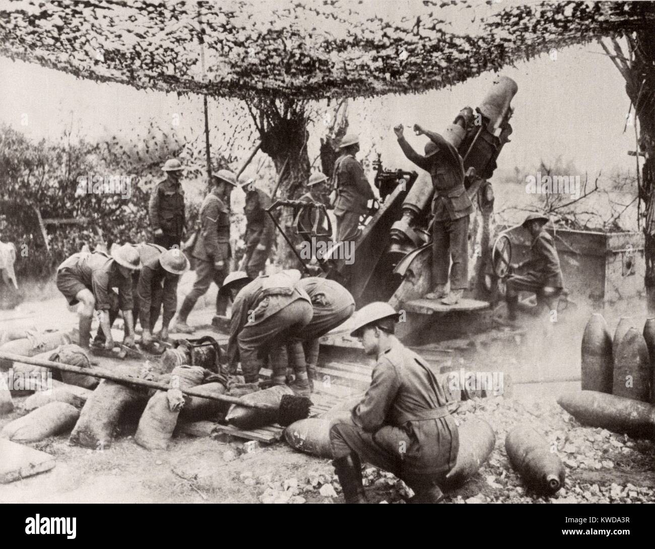 World War 1. Australians firing a 9.2 inch Howitzer out of the Ypres salient during the Battle of Passchendaele. I threw a 380 lb. shell up to 26,000 yards (14.7 miles). The firing lanyard has just been pulled and a crew is waiting to reload. The screen above camouflages the guns position from enemy aircraft. At Vormezeele, Sept 1917. (BSLOC 2013 1 147) Stock Photo