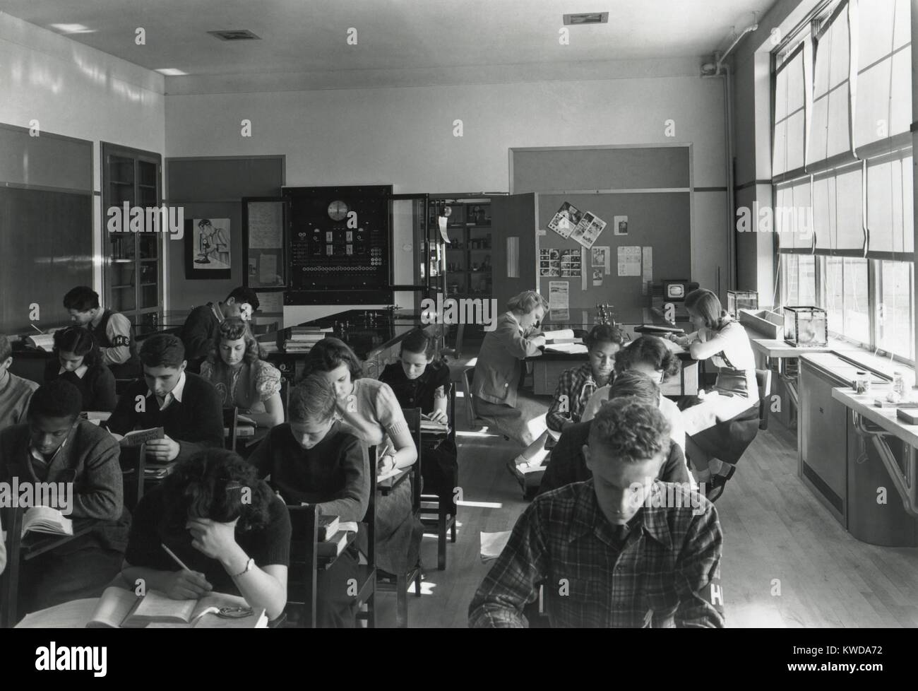 High school physics classroom in Harrison, N.Y., an affluent suburbs of New York City, on Dec. 9, 1940. The school is racially integrated, with an African America student at far left (BSLOC 2016 7 12) Stock Photo