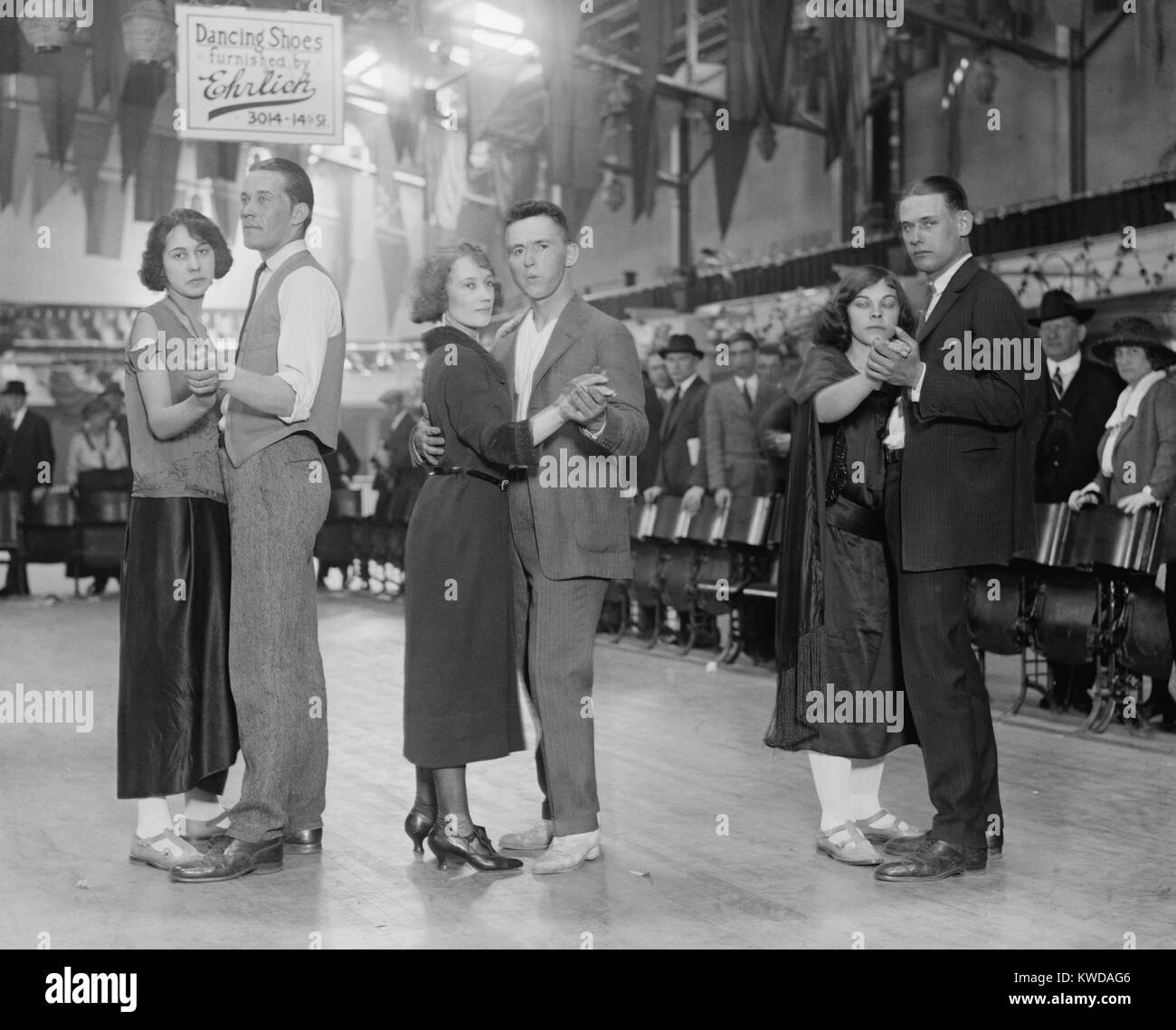 Three couples about to begin a round of Marathon dancing, April 20, 1923, in Washington, D.C. Above them is an advertisement, 'Dancing Shoes Furnished by Ehrlich' (BSLOC 2016 8 97) Stock Photo