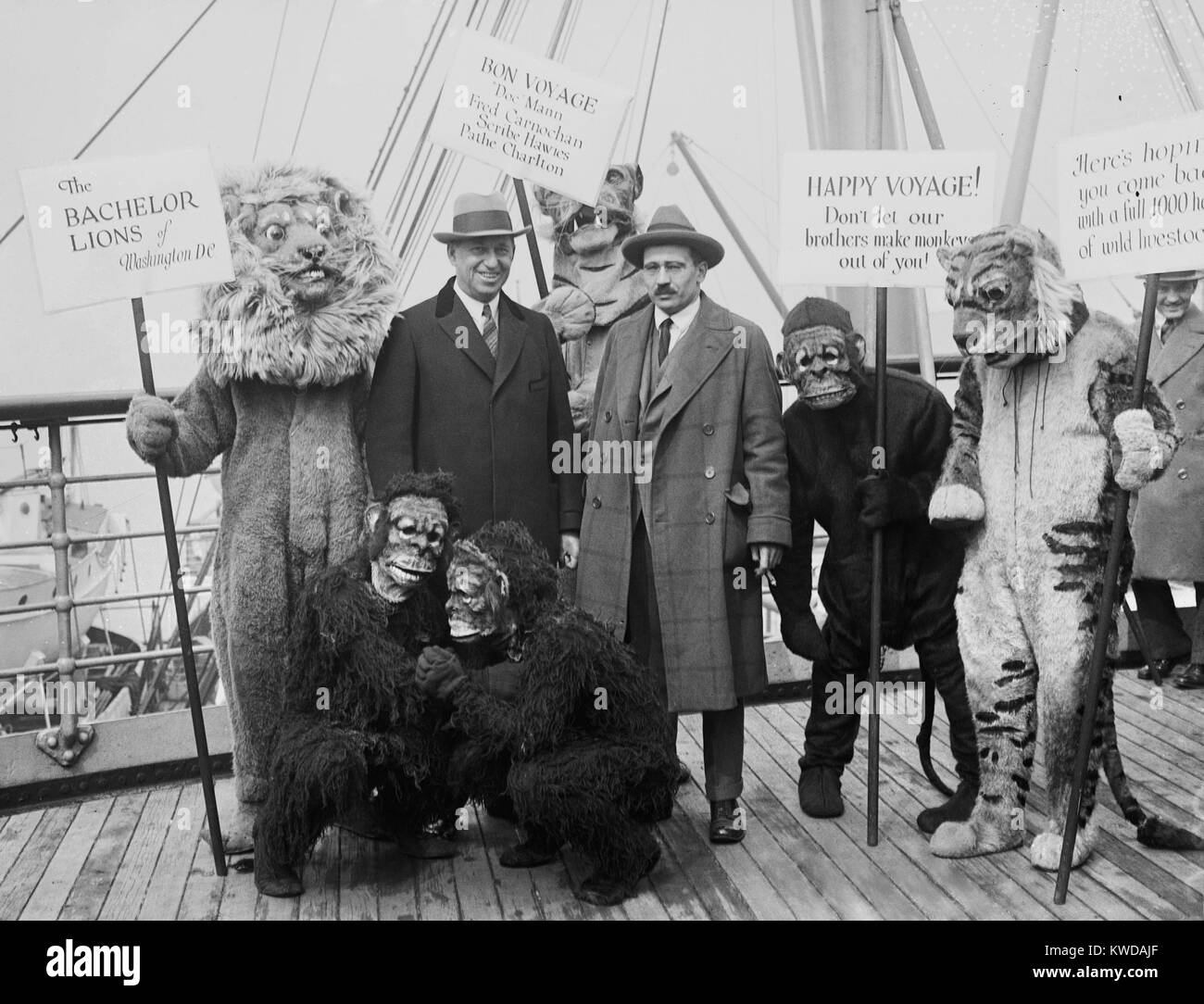 William M. Mann (right), sets off on Smithsonian-Chrysler Expedition to Tanganyika and East Africa. Standing with the expedition sponsor, Walter P. Chrysler (left), the Director of the National Zoo, is surrounded by costumed supporters. The 1926 expedition returned with a total of 1,203 animals for the Zoo including: 158 mammals, 584 birds, 56 snakes, 12 lizards, 393 tortoises, and 1 frog (BSLOC 2016 10 128) Stock Photo