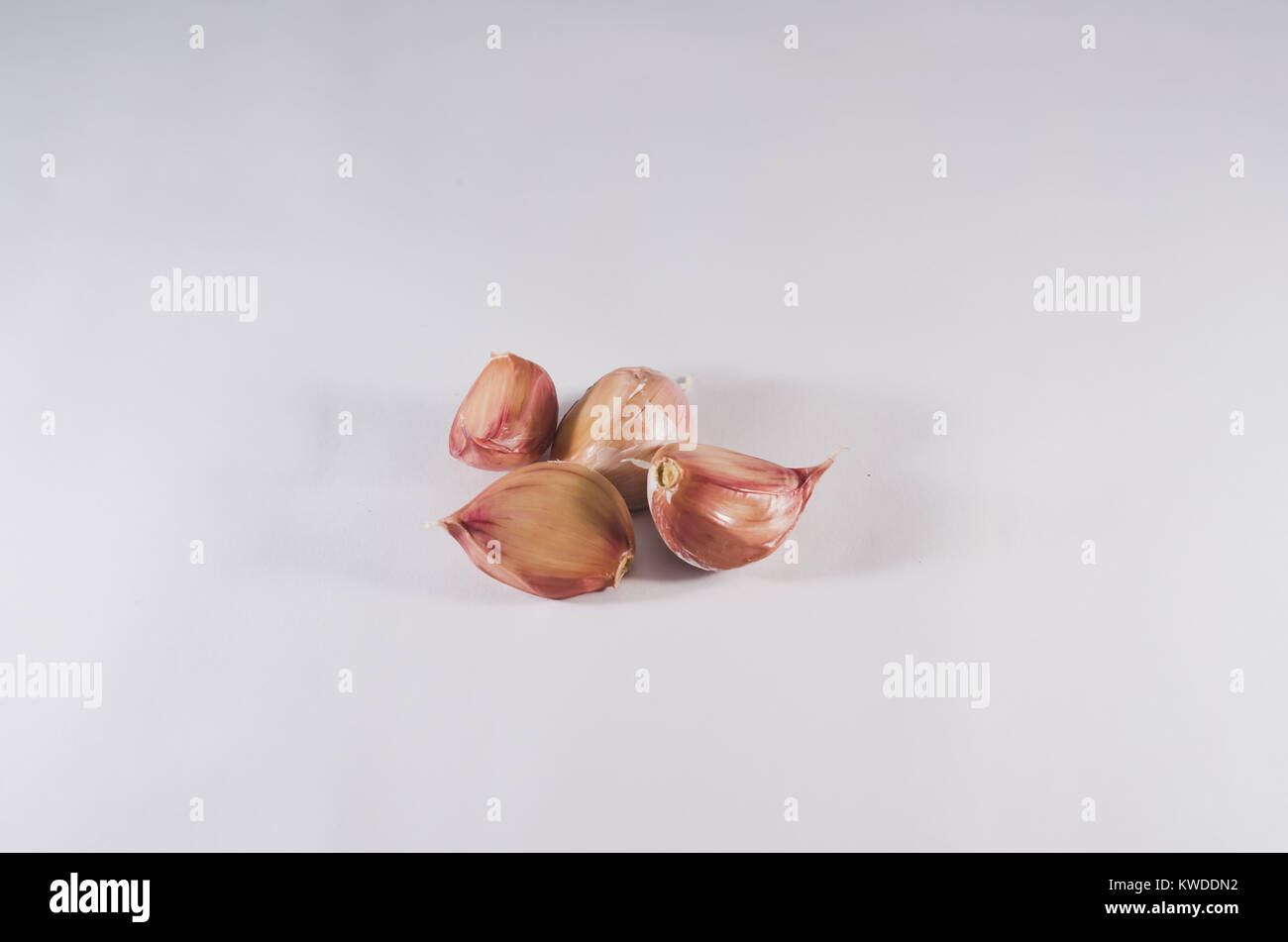 Garlic cloves isolated on white background Stock Photo - Alamy