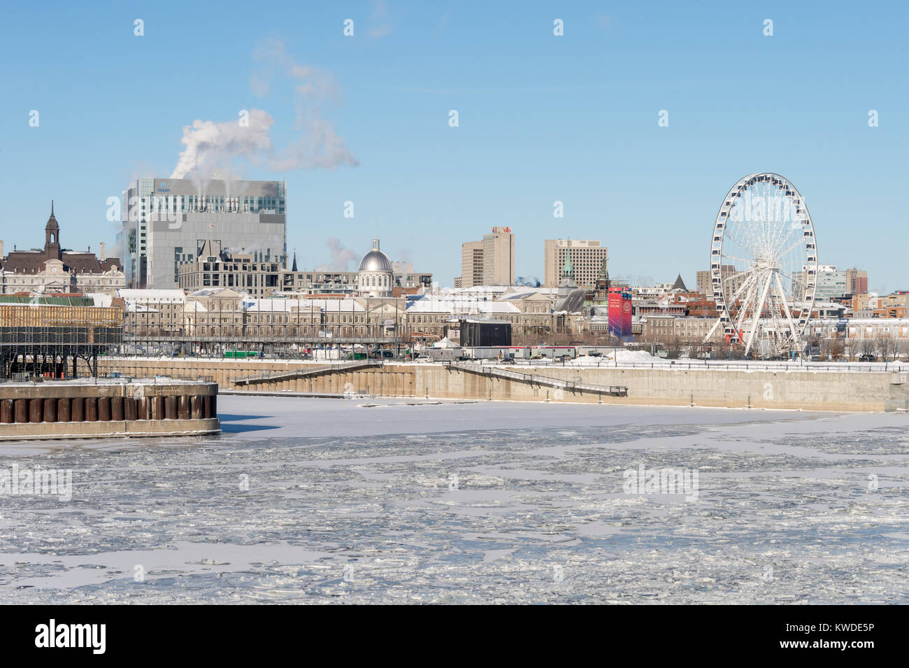 Montreal, CA - 1 January 2018: Montreal Skyline and Frozen St Lawrence River in winter Stock Photo