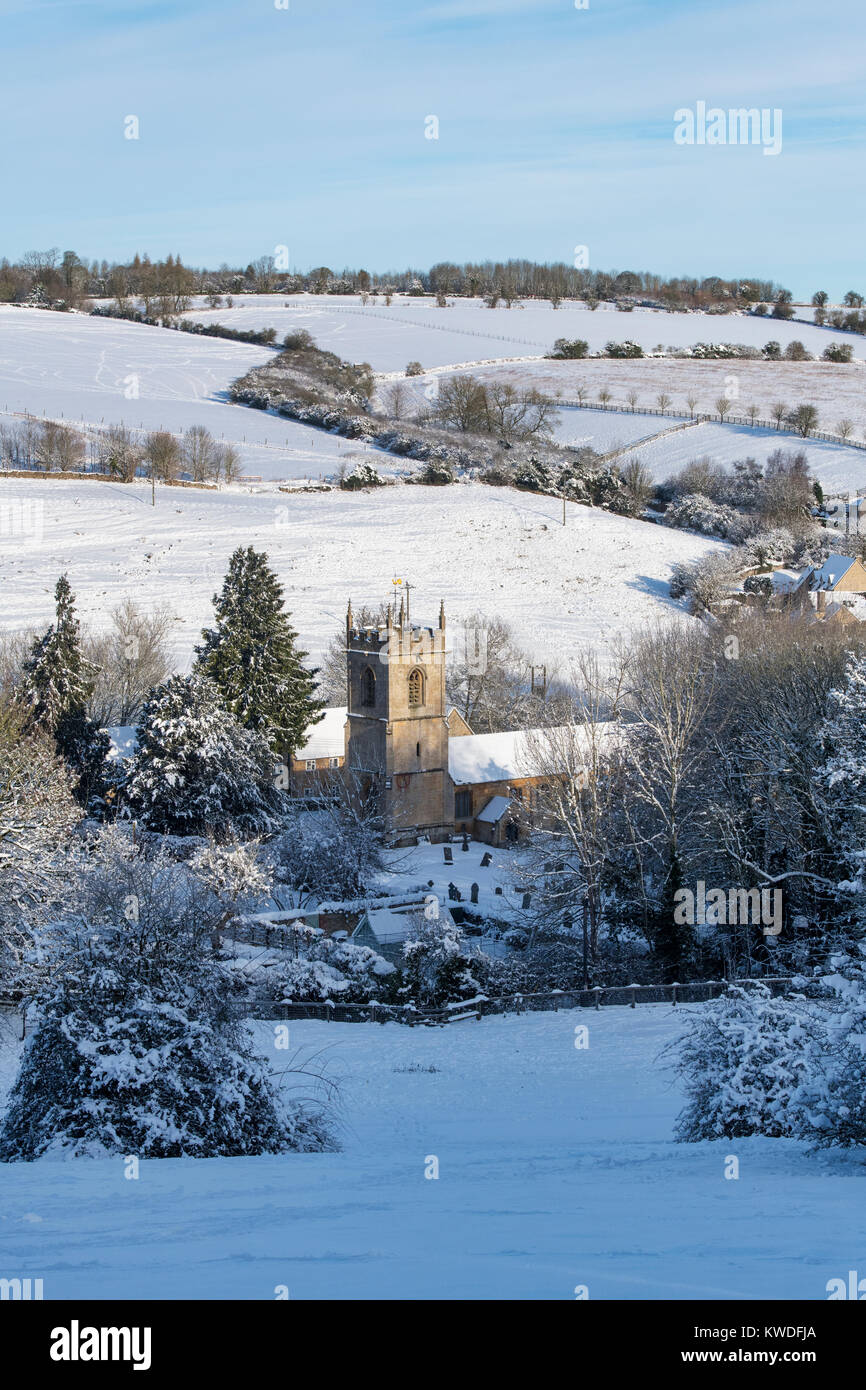 St Andrews Church, Naunton village in the snow in December. Naunton, Cotswolds, Gloucestershire, England Stock Photo