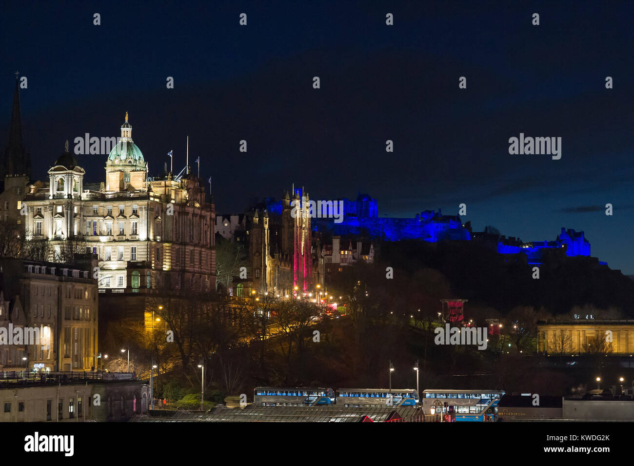 The Bank of Scotland HQ on the Mound and Edinburgh castle illuminated in blue during the new year celebrations. Stock Photo