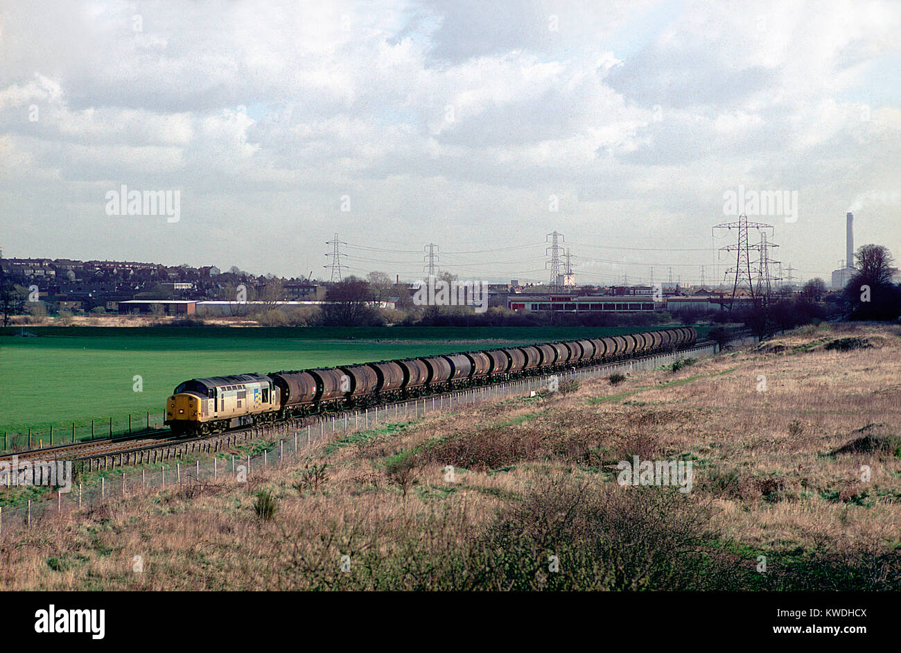 A class 37 diesel locomotive number 37709 working a train of loaded bitumen tanks at Crayford in south London. 17th March 1994. Stock Photo