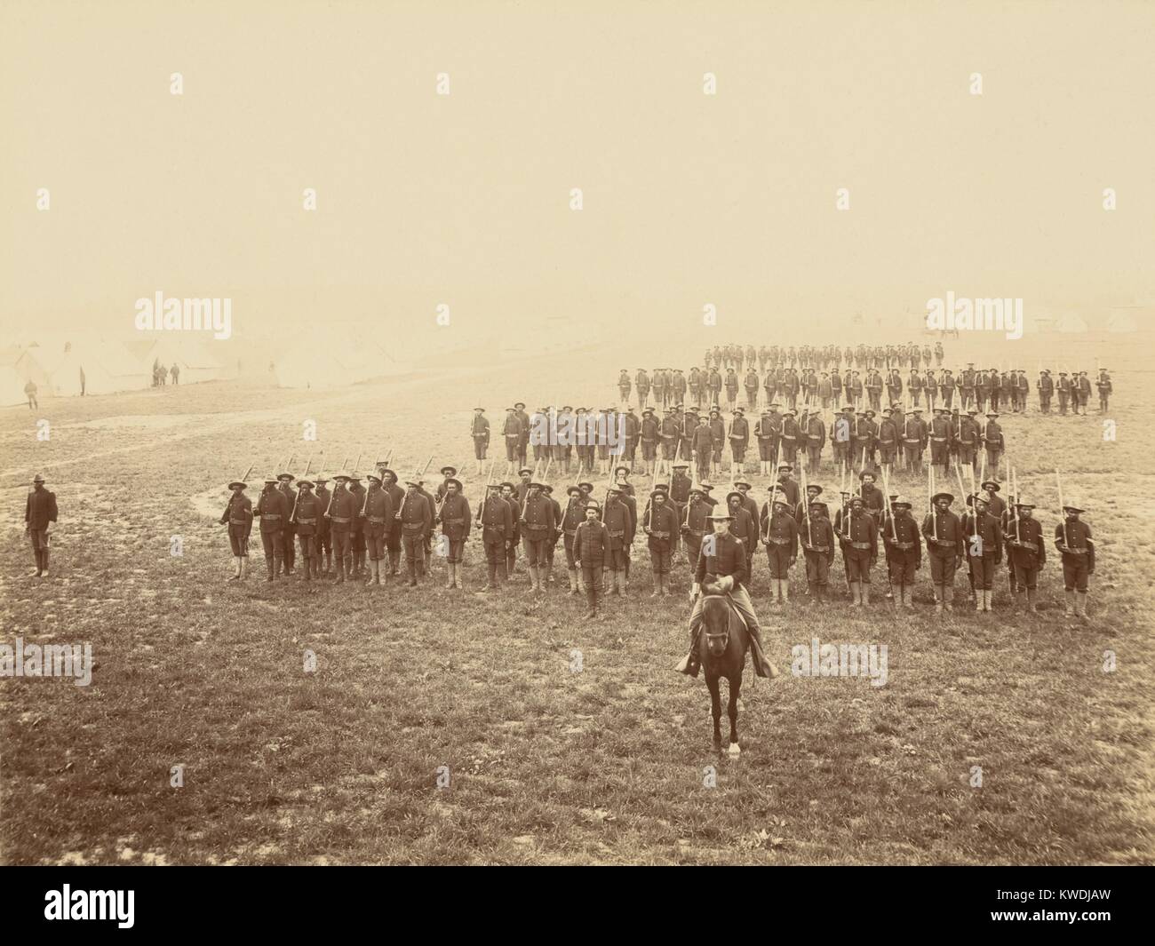 African American soldiers in formation at Camp Meade, Pennsylvania, May 1899. African Americans, most from the southern states, volunteered hoping that military service would improve their civil rights. In Cuba they were called the Immunes due to their under 10% rates of yellow fever, compared to the 75% for white soldiers (BSLOC 2017 10 14) Stock Photo