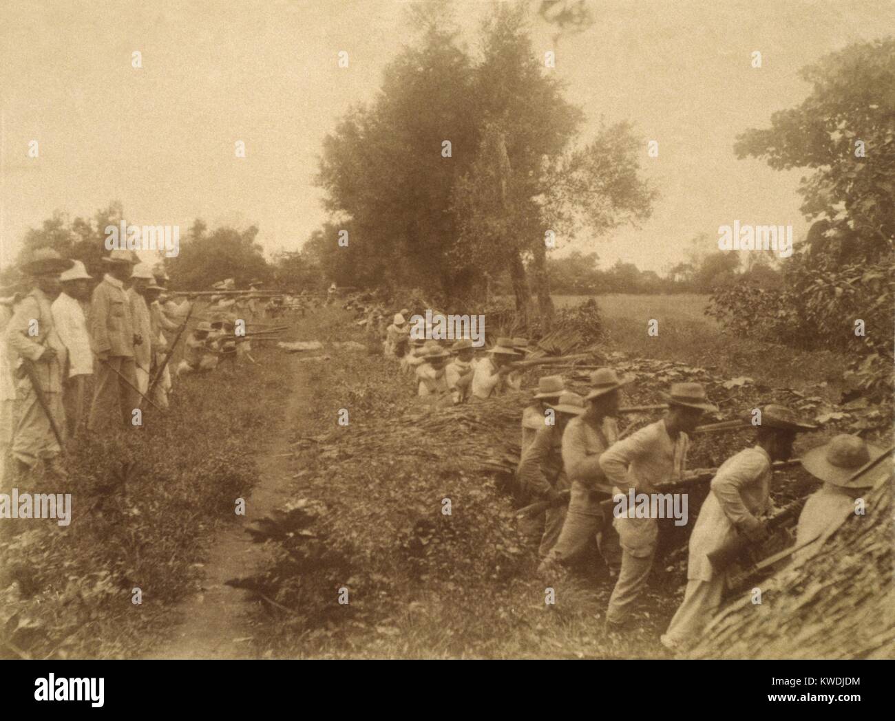 Philippine revolutionary soldiers fire in the trenches at Malate, Philippines, in Feb. 1899. This was the beginning of the Philippine-American War, prompted by US denial of Filipino claims for national independence (BSLOC 2017 10 70) Stock Photo