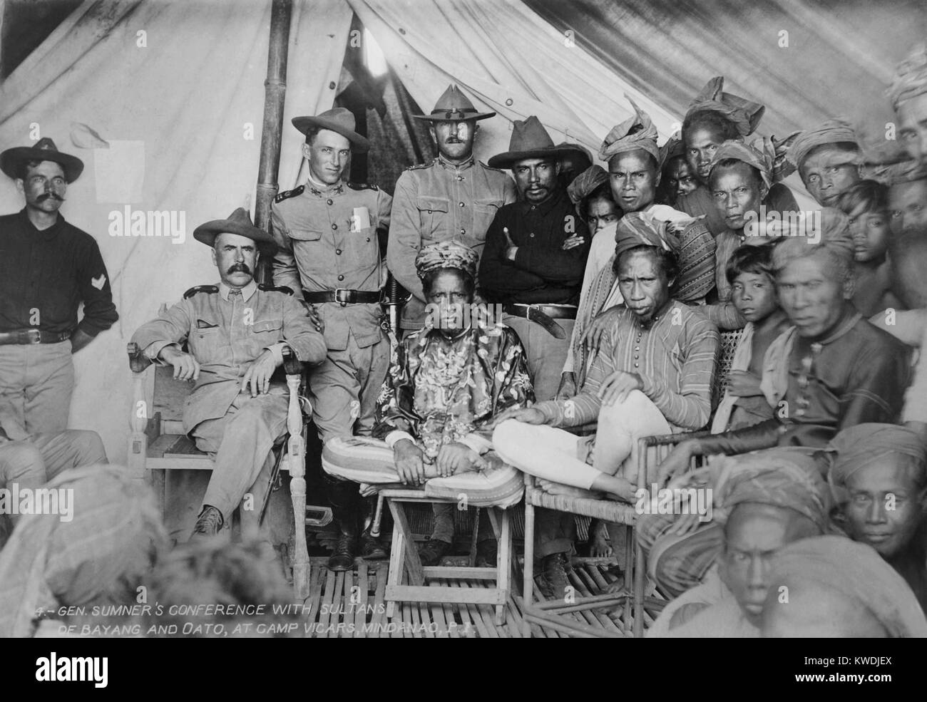 Gen. Samuel Sumners conference with Sultans of Bayang and Oato, at Camp Vicars, Mindanao, P.I. 1902. Capt. John Pershing, in his campaign hat, stands in center behind one Sultan. US occupation forces sought to bring change Moro society in the southern Islamic Philippines, specifically to end Moro practice of Sharia law, polygamy, slavery, woman stealing, and piracy (BSLOC 2017 10 96) Stock Photo