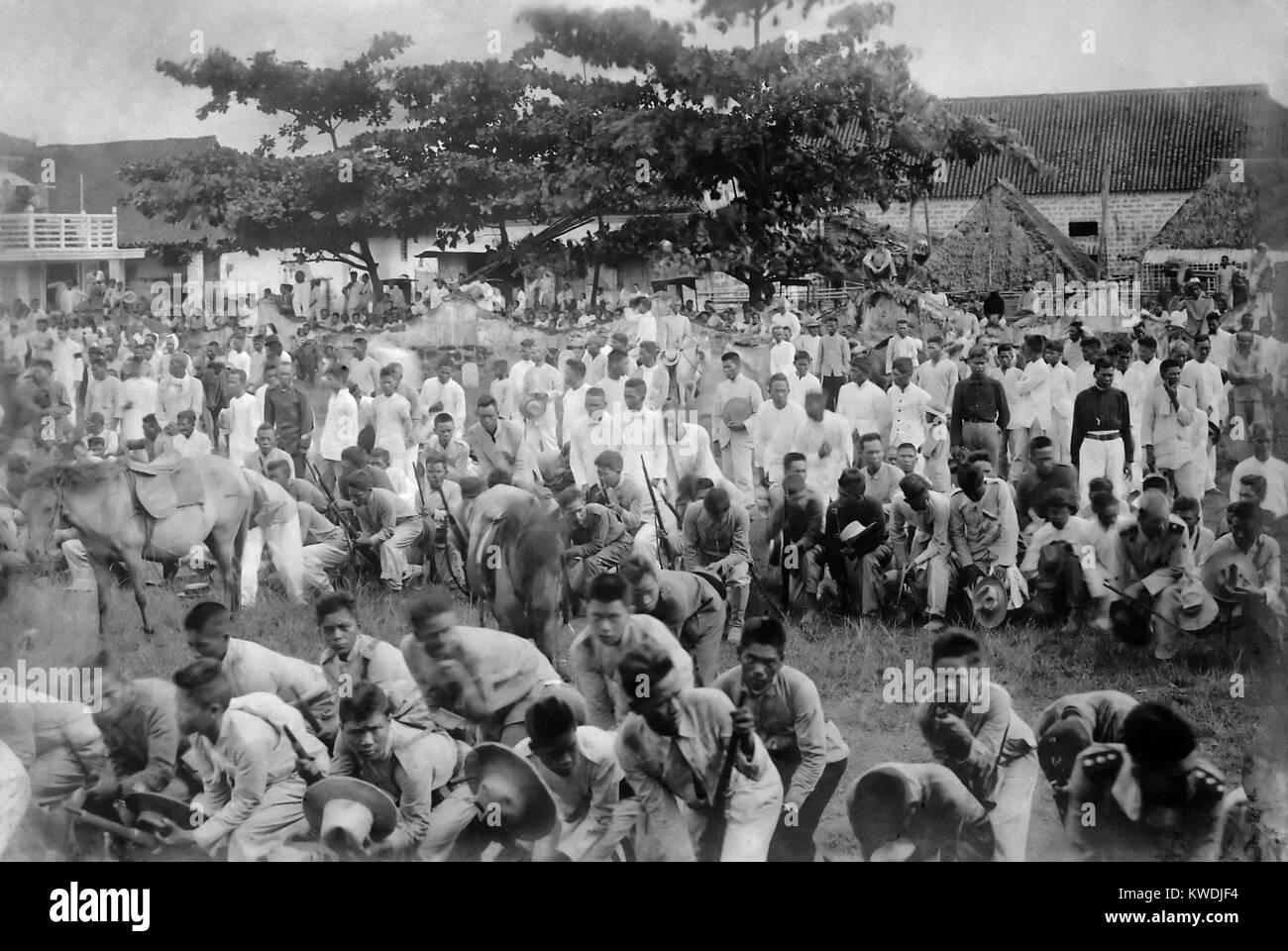 Prayer Before the Surrender as Filipino men surrender their weapons. US army photo from the Dept. of Mindanao and Jole, the Islamic Islands in the Southern Philippines. In Sept. 1911, Gen. John Pershing the ordered the disarmament of the Southern Philippines by December 1, 1911 (BSLOC 2017 10 99) Stock Photo