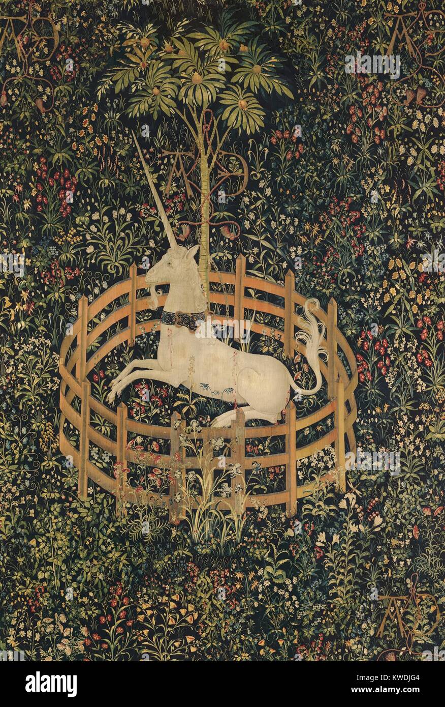 THE UNICORN IN CAPTIVITY, 1495–1505, Netherlandish, Northern Renaissance tapestry. Fertility appears to be the theme of this tapestry. The unicorn rests under a pomegranate tree—a medieval symbol of fertility and marriage. Many of the other plants echo this theme of marriage and procreation (BSLOC 2017 16 118) Stock Photo