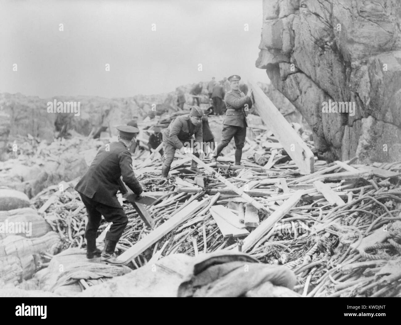 Red Cross men and soldiers searching the wreckage of the SS OTRANTO for of victims on Machrie Bay. The troopship, SS OTRANTO, broke up and sunk after a collision during a storm on Oct. 6, 1918, killing 470 including its British crew of 96 and 357 US soldiers (BSLOC 2017 17 115) Stock Photo