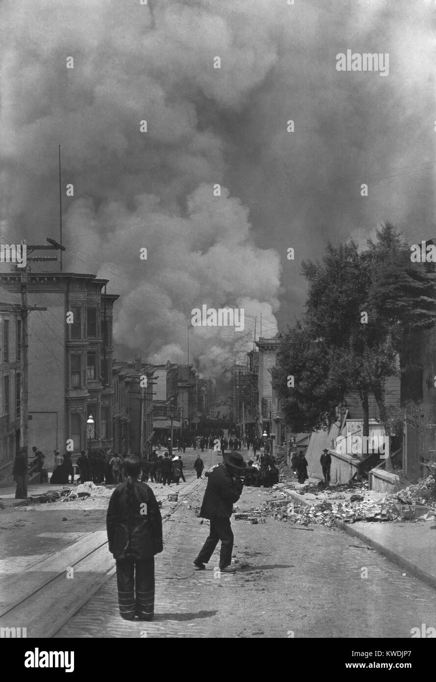 Chinese residents of San Francisco watching the fire following the earthquake of April 18, 1906. In the distance are crowds of people moving away from the fire zone. Photo by Arnold Genthe (BSLOC 2017 17 19) Stock Photo