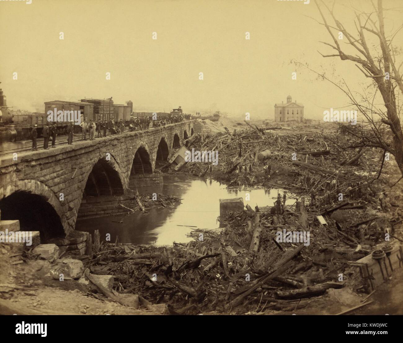 Debris at Pennsylvania Railroad stone bridge, after the Johnstown Flood of May 31, 1889. This was the most horrific site of the disaster. The bridge blocked the onslaught of tons of debris, carried by the flood waters. A fire broke out in the 30 acres of debris, burning for three days, killing scores of people still trapped in the houses (BSLOC 2017 17 80) Stock Photo