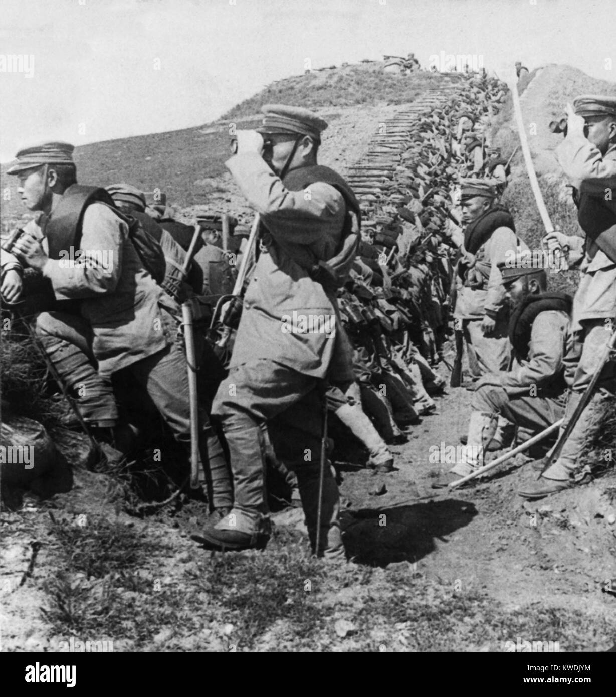 Entrenched Japanese soldiers expecting an attack from Russian cavalry, Tehling, Manchuria. Troops are lined along a ditch, as their officers search the distance with binoculars (BSLOC 2017 18 112) Stock Photo
