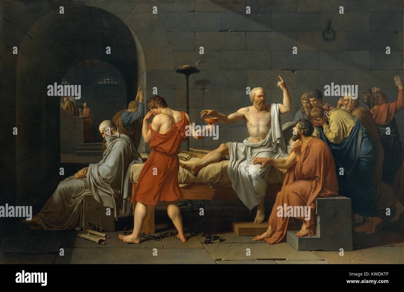 THE DEATH OF SOCRATES, by Jacques Louis David, 1787, French Neoclassical painting, oil on canvas. Greek Classical philosopher Socrates about to drink poison hemlock as the price of maintaining his beliefs. Most of his disciples are grieving, except for the meditative Plato seated on left. Apollodorus, is behind Plato, leaning against the wall while Crito grasps Socratess thigh (BSLOC_2017_9_145) Stock Photo