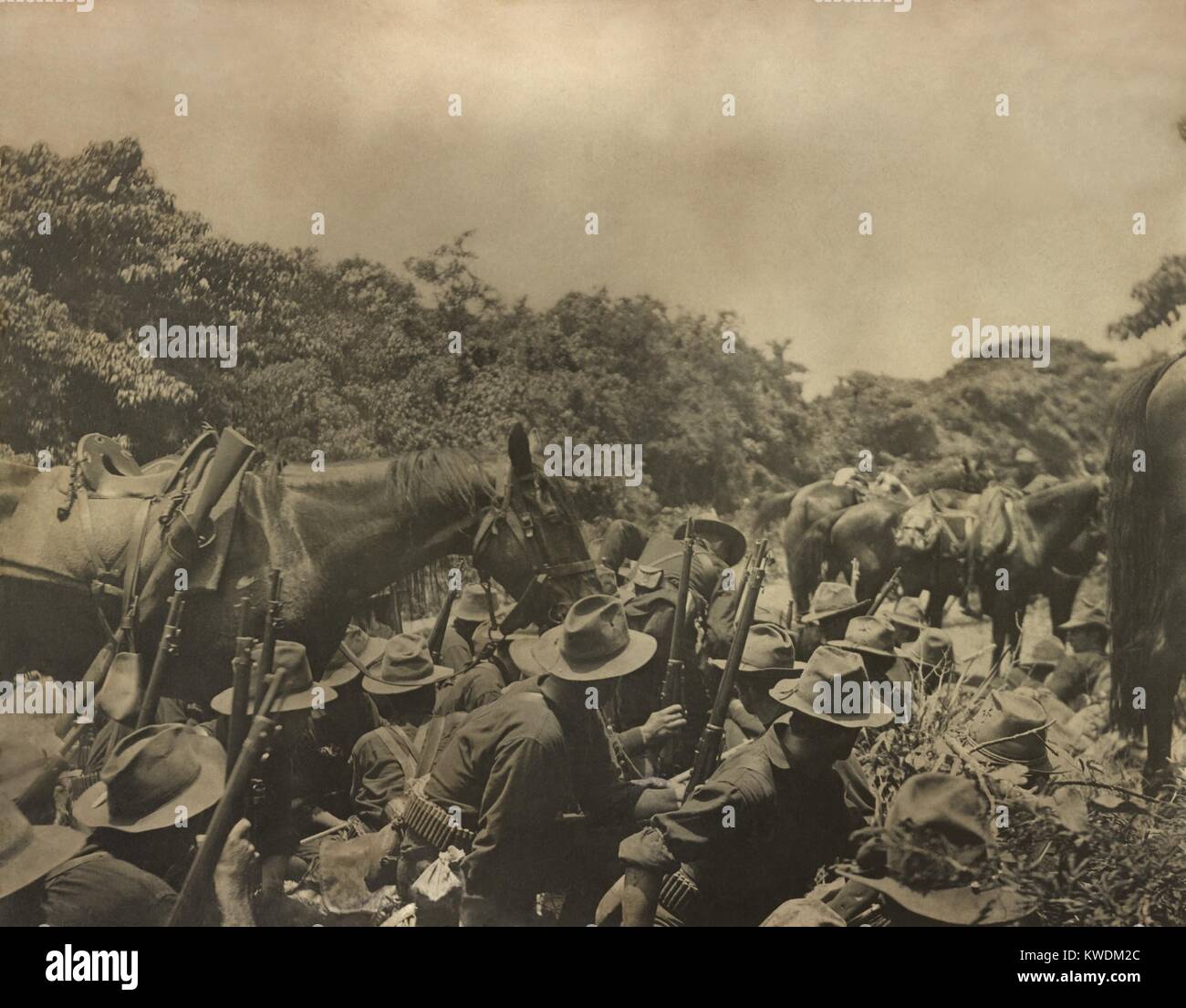 US 16th Infantry under Spanish fire in San Juan creek bottom, during the Battle of San Juan Hill. July 1, 1898, Spanish-American War, during the Siege of Santiago (BSLOC_2017_10_31) Stock Photo