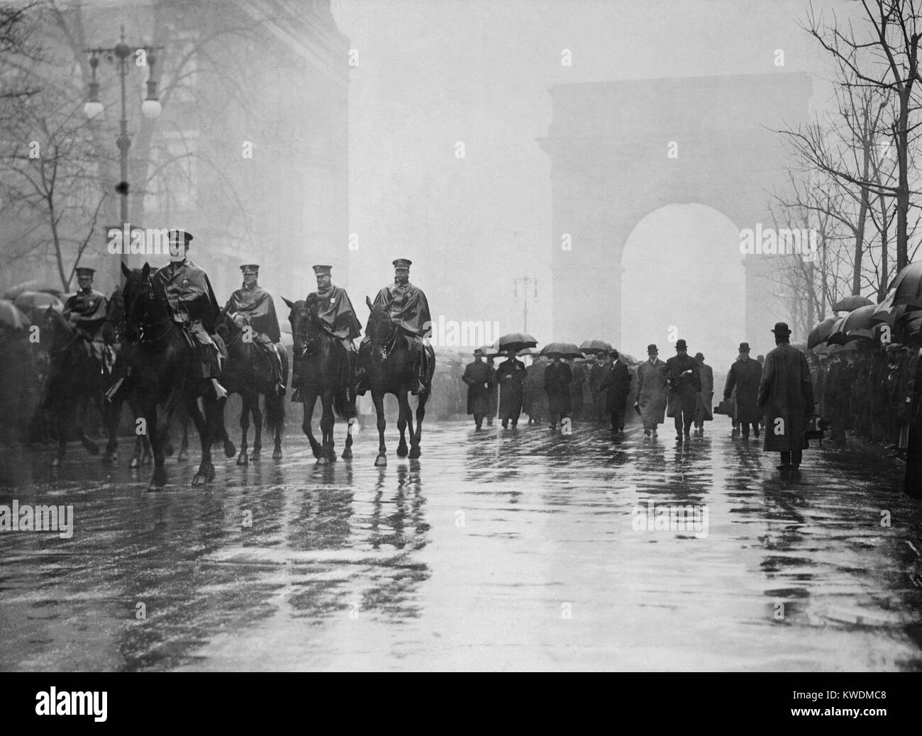 Trade Union procession for 145 Triangle Waist Co. fire victims. Men on horseback lead others in the rain on Fifth Avenue with the Washington Square in the background. Union activism prompted the Fire Department to improve building inspections and enforce fire codes (BSLOC 2017 17 103) Stock Photo