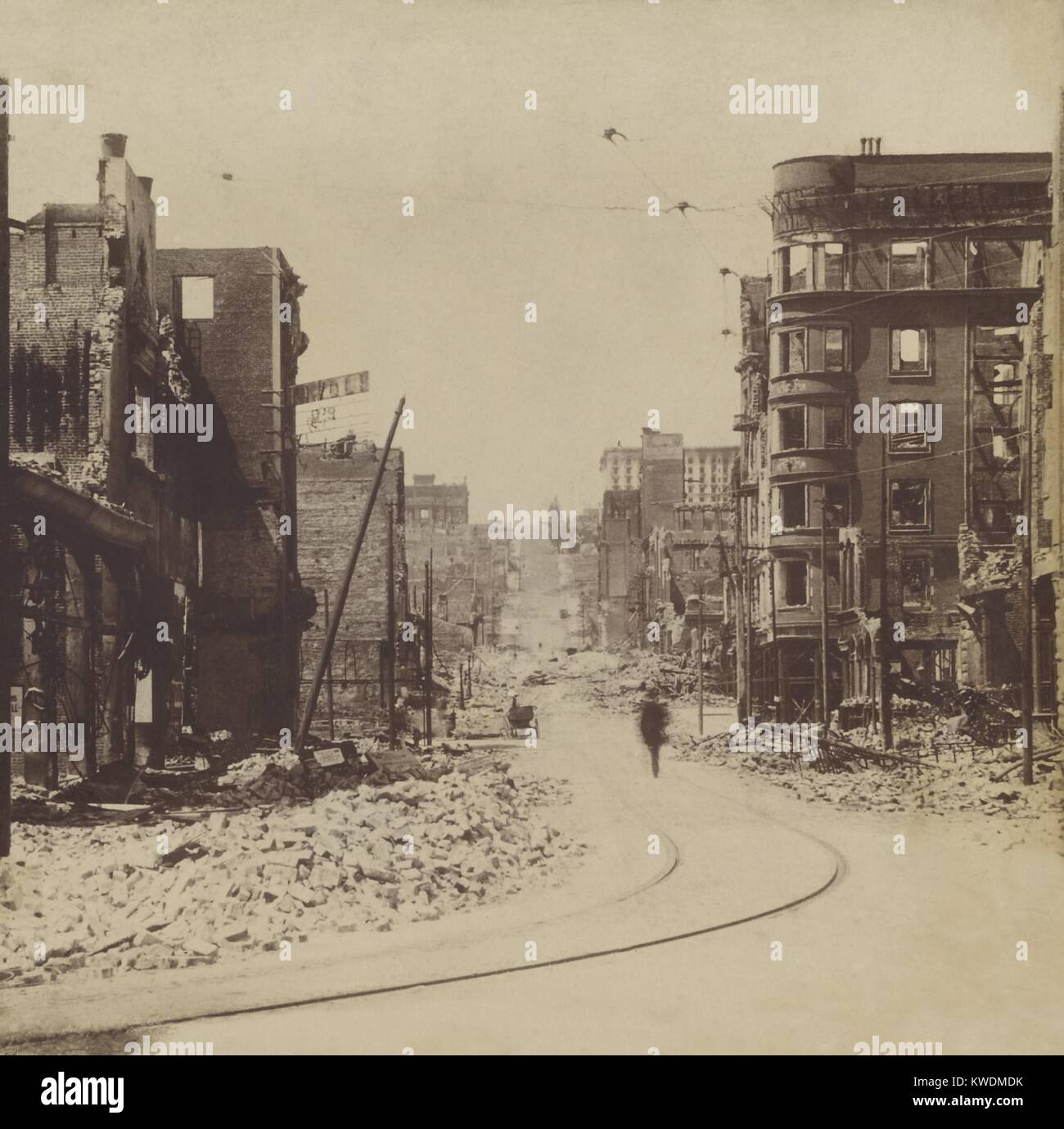 A man walks on Mason St. after the April 18, 1906, San Francisco earthquake and fire. The photo taken from Market St. shows rubble from destroyed and damaged buildings (BSLOC 2017 17 24) Stock Photo