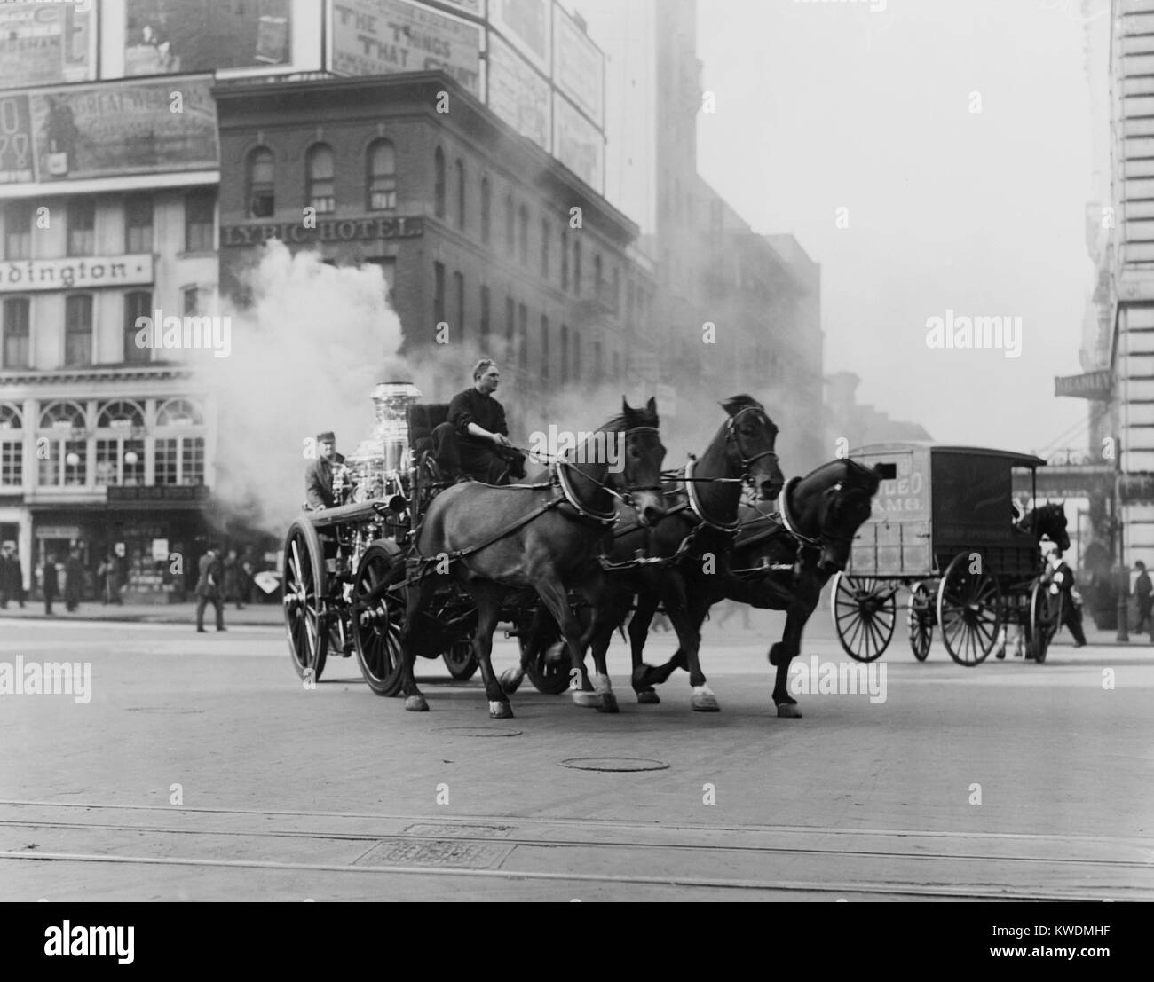 Horse drawn fire engine speeds on West 43rd Street and Broadway, NYC, 1910-15. The steam is from the engines boiler which powered a pump to spray on the fire (BSLOC 2017 17 99) Stock Photo