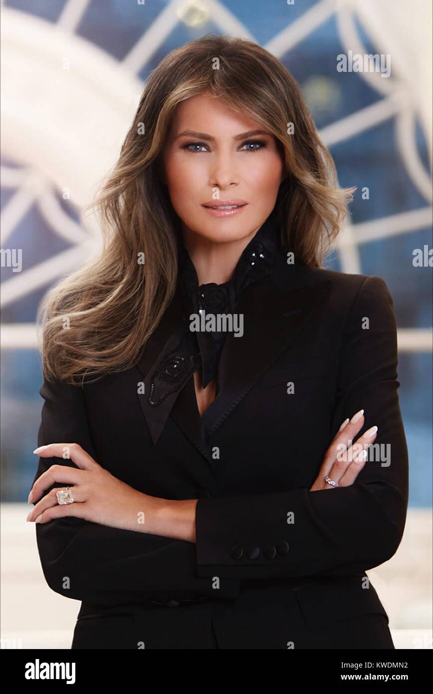 Official photo of First Lady Melania Trump, in the White House residence. She stands with her arms crossed, smiling, and looking into the camera, with slight smile on her face. She wears a black suit designed by Dolce & Gabanna, and her 25-carat-diamond ring. Photo was shot by three Belgian photographers – Regine Mahaux, whose name is attached to the portrait, assisted by her brother, Benoit Mahaux, and Wim Van De Genachte (BSLOC 2017 18 158) Stock Photo