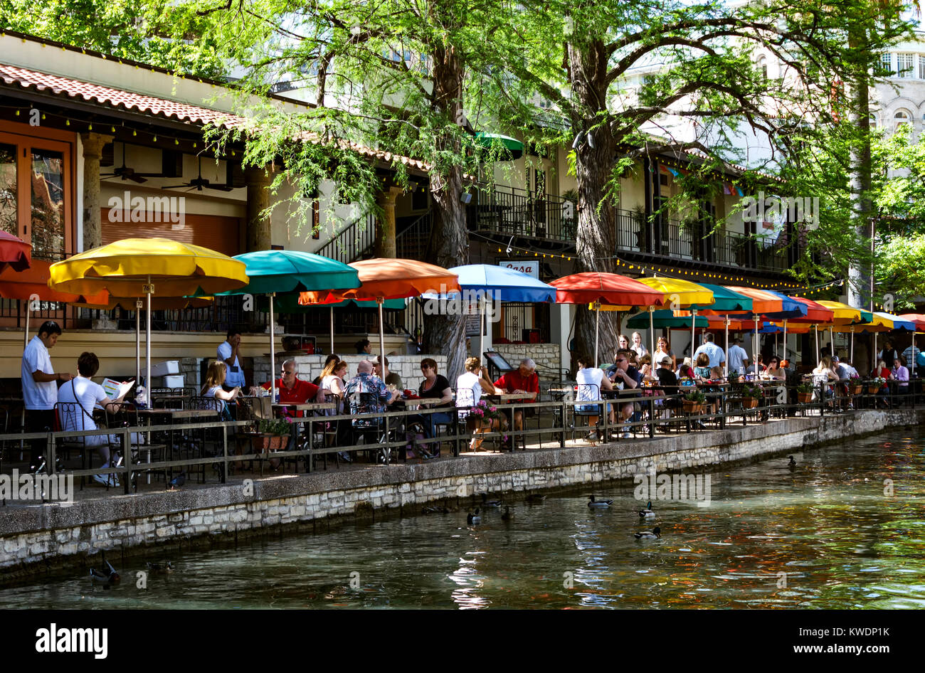 Colorful umbrellas and people, San Antonio River along the Riverwalk, San Antonio, Texas USA Stock Photo