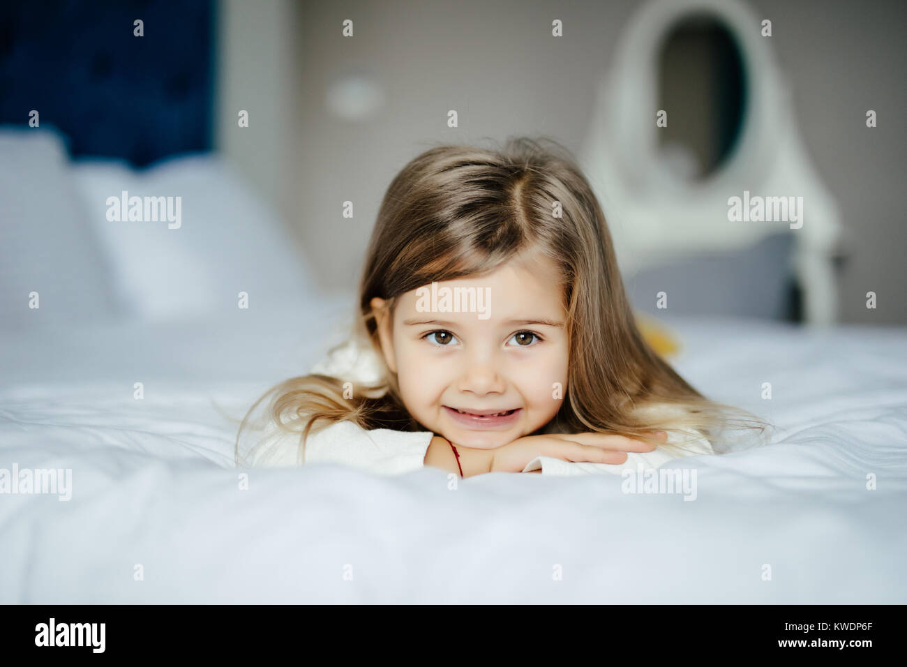 Cute little girl in pajamas on the bed in the morning Stock Photo Alamy