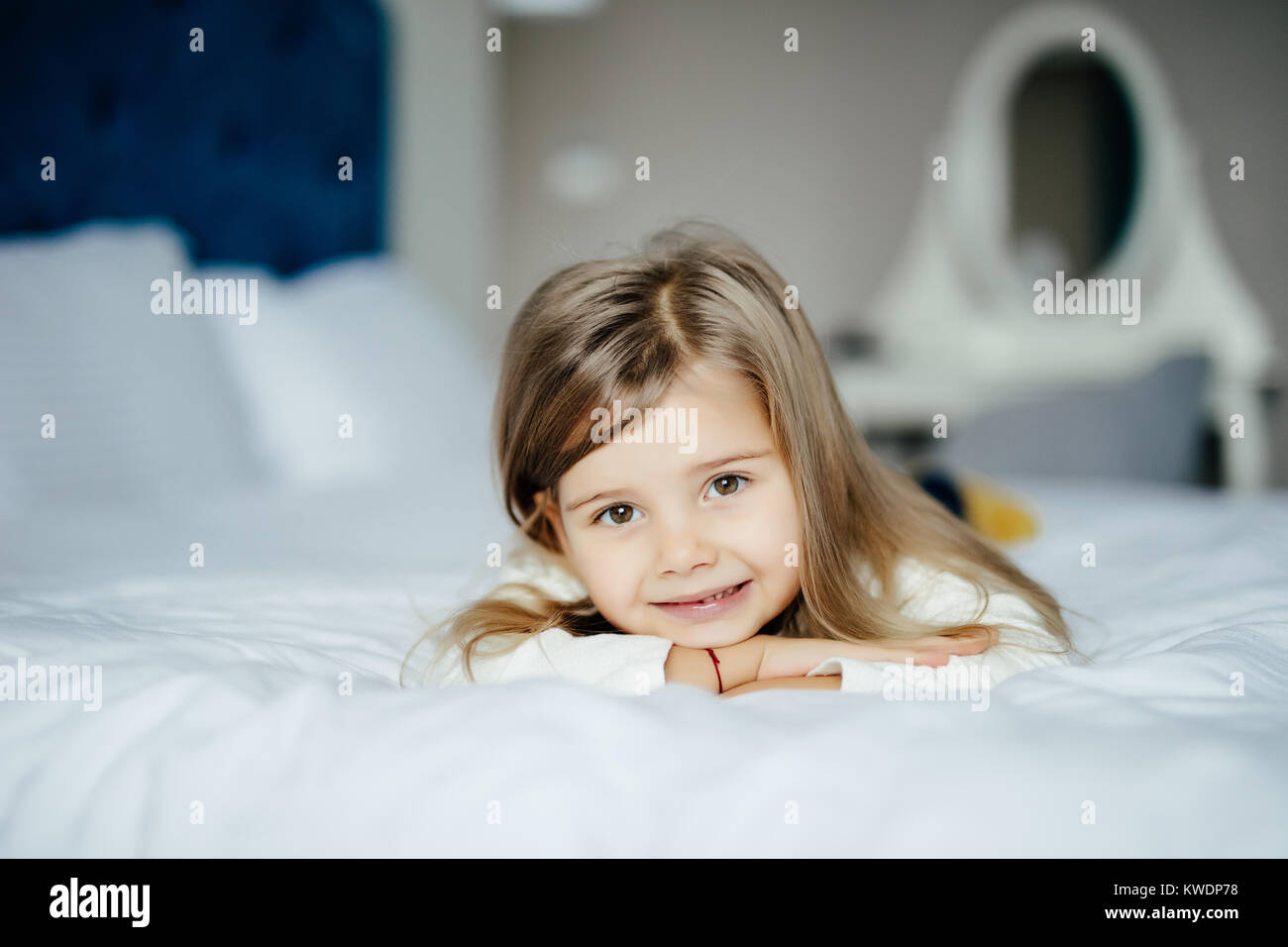 Cute little girl in pajamas on the bed in the morning Stock Photo - Alamy