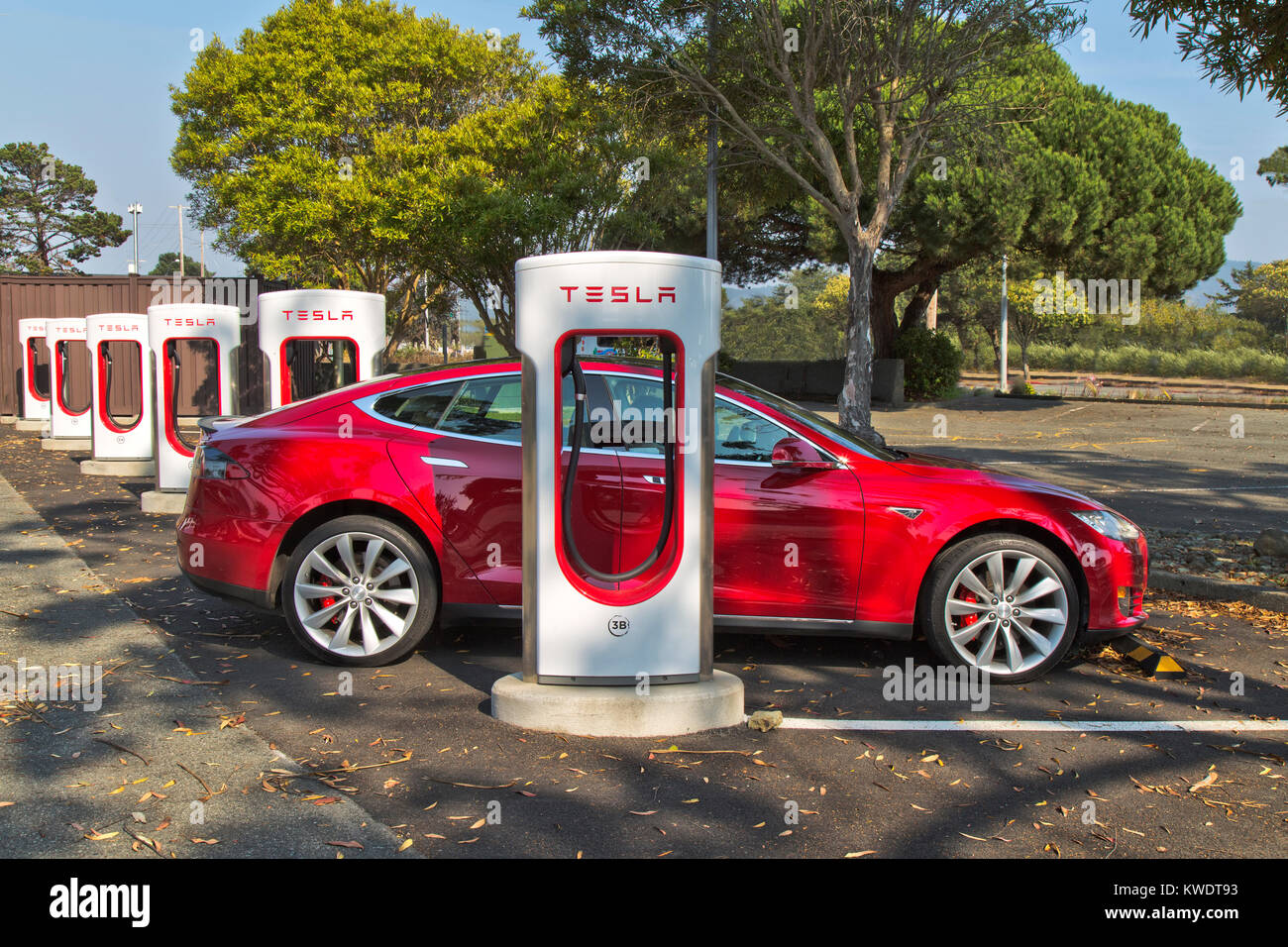 Tesla 'S'  sedan connected to 480 volt (fast charging) Supercharger Station. Stock Photo