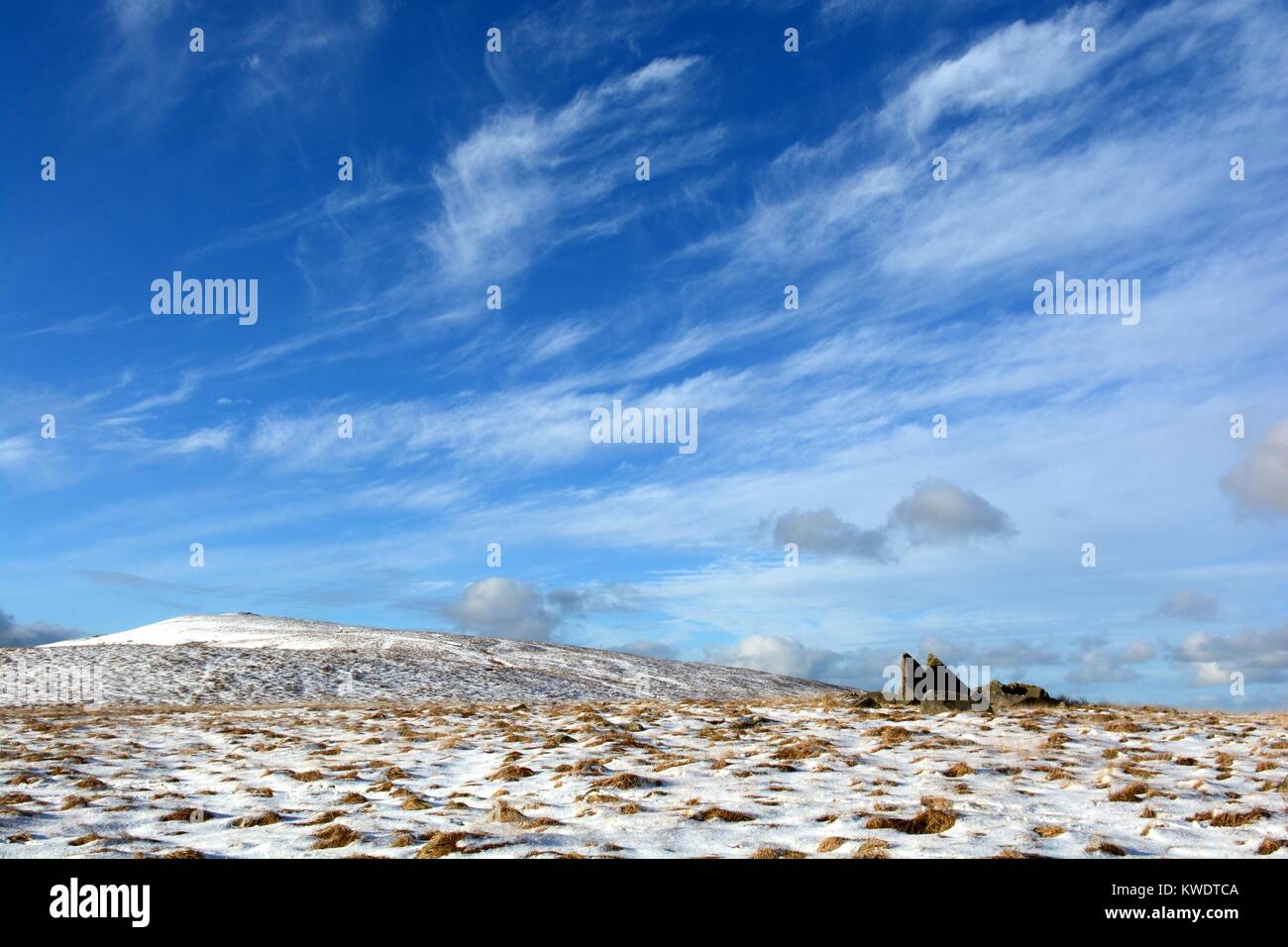 Wispy strands of Cirrus clouds in blue sky over Foel Feddau winter snow Preseli Hills Pembrokeshire Wales Cymru UK GB Stock Photo