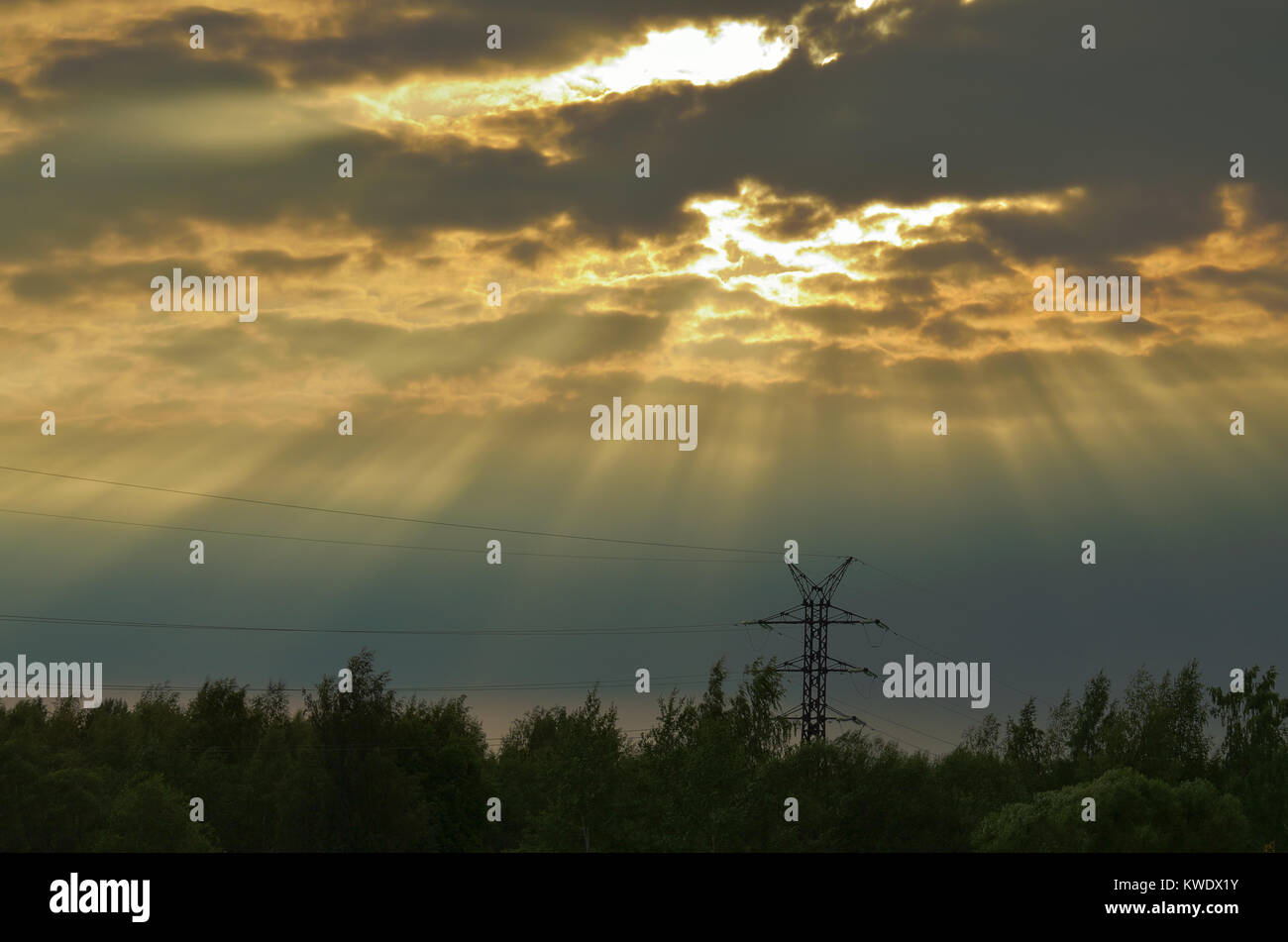 The sun's rays at sunset.Light breaks through the clouds. Stock Photo