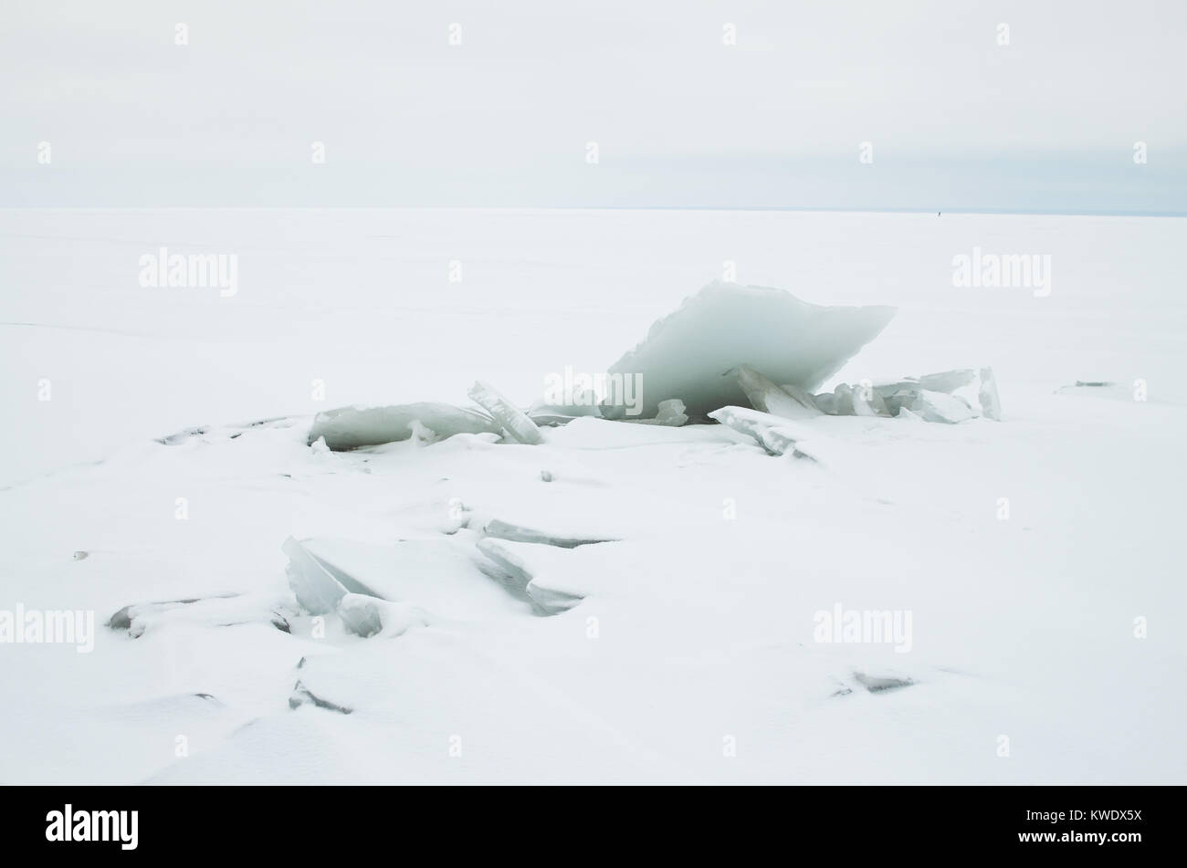 A large block of ice on the shore white ice is very large stock photo