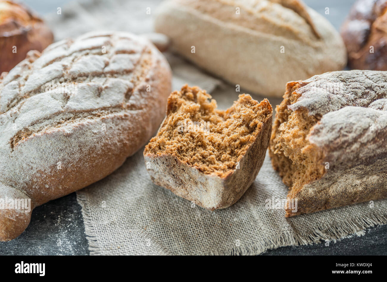 Whole grain breads on the dark wooden background Stock Photo - Alamy