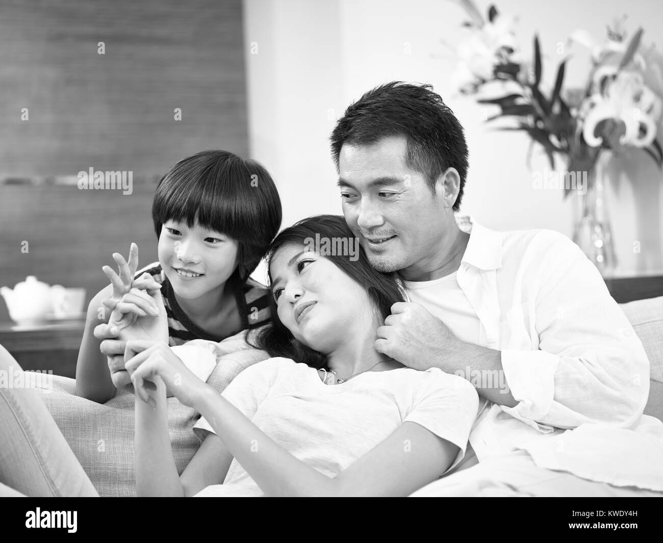 asian parents with one child enjoying time together at home, black and white Stock Photo