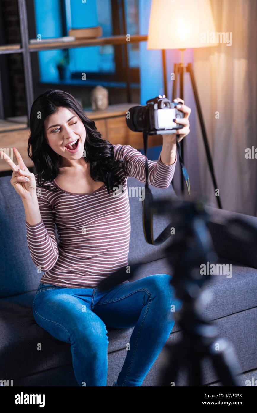 Happy delighted woman showing V sign Stock Photo