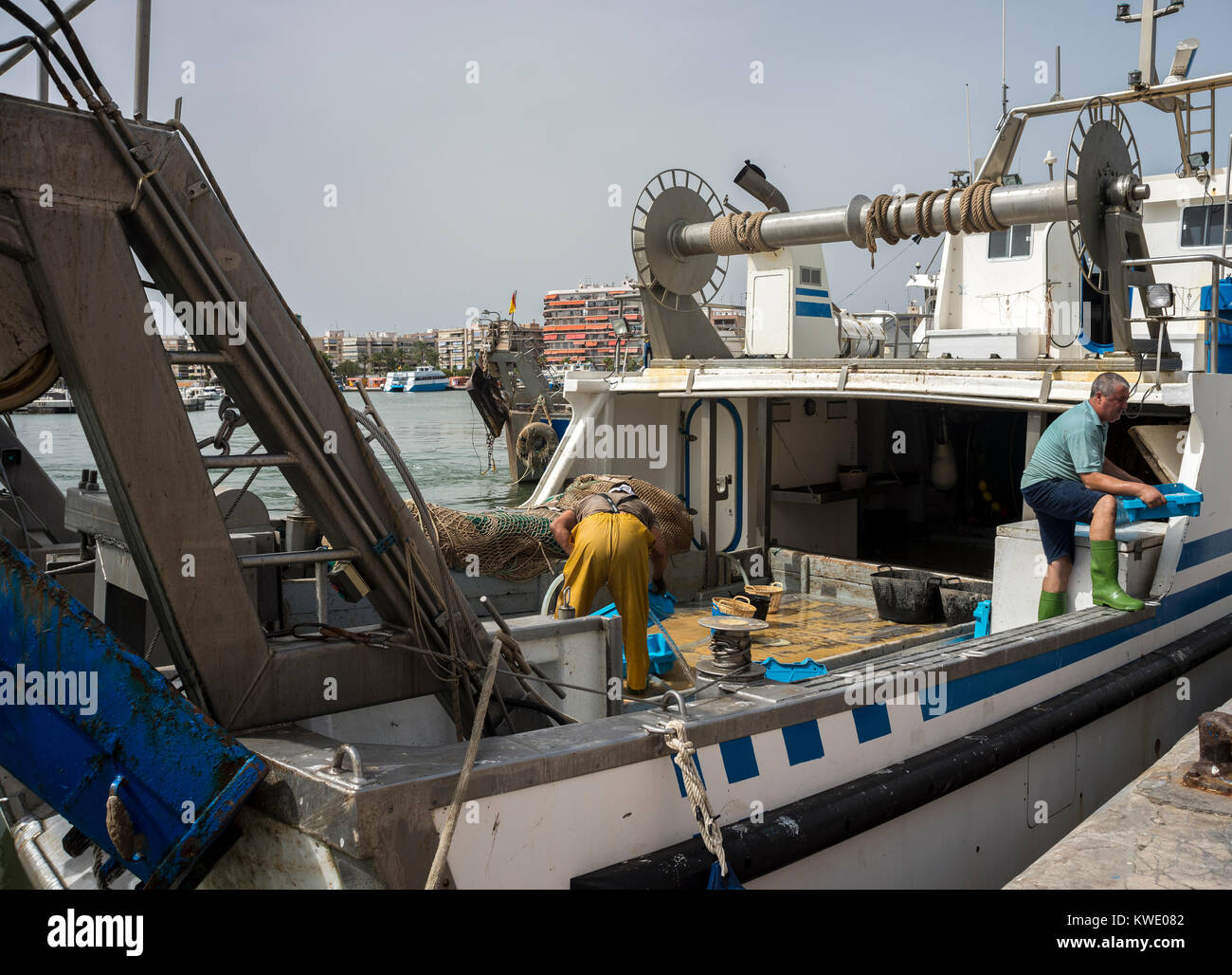 SANTA POLA – JULY 21, 2016: Fishing boats unloading fish in the port of Santa Pola, Alicante, Spain, on July 21, 2016 Stock Photo