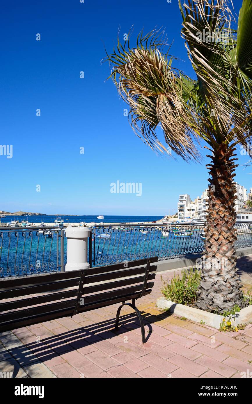 Wrought iron railings along the promenade with views of the harbour and ...