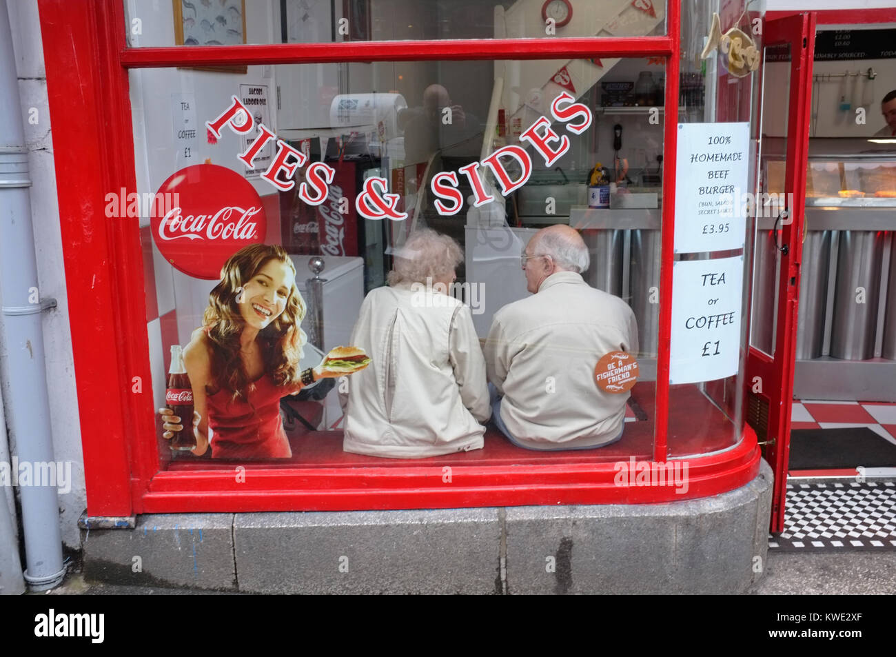 Two retired people in a chip shop Stock Photo