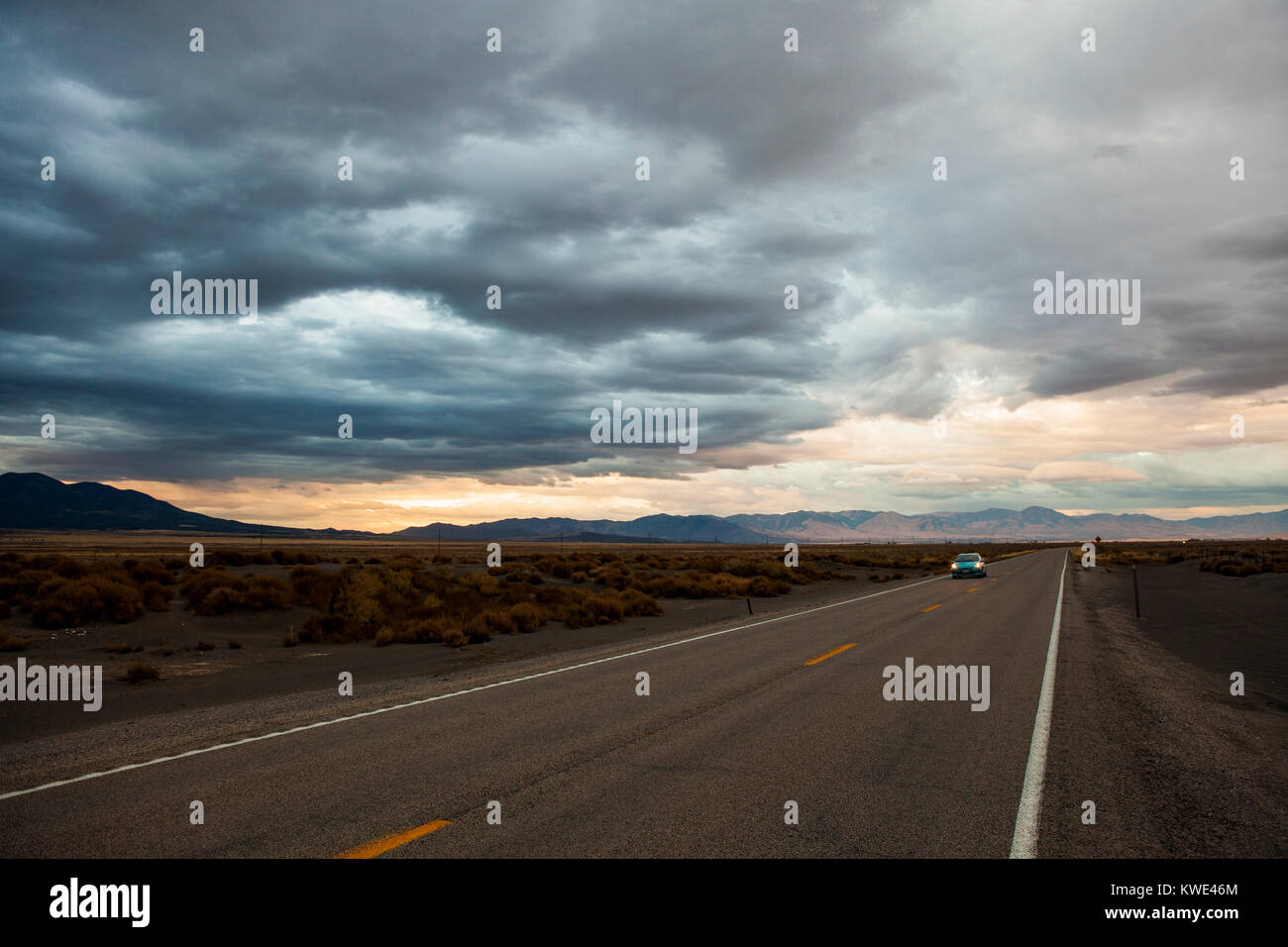 Car on country road against stormy clouds Stock Photo - Alamy
